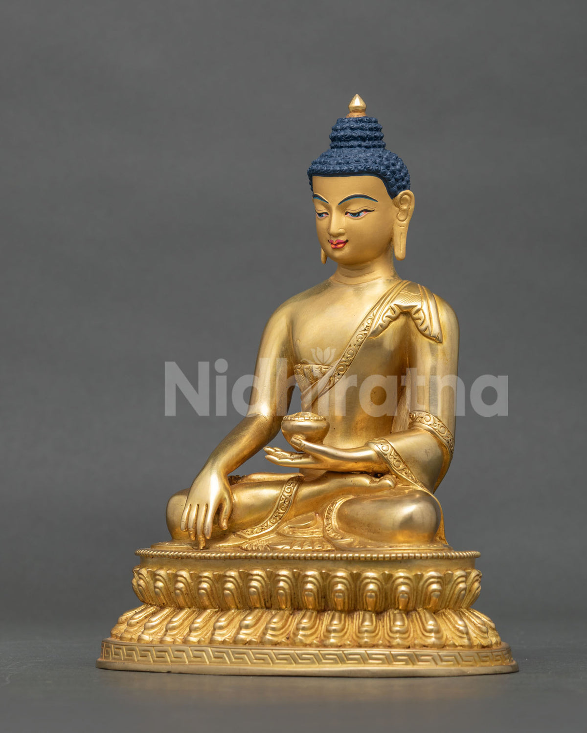 Shakyamuni buddha statue with gold fire gilded finish and 24k gold painted face.