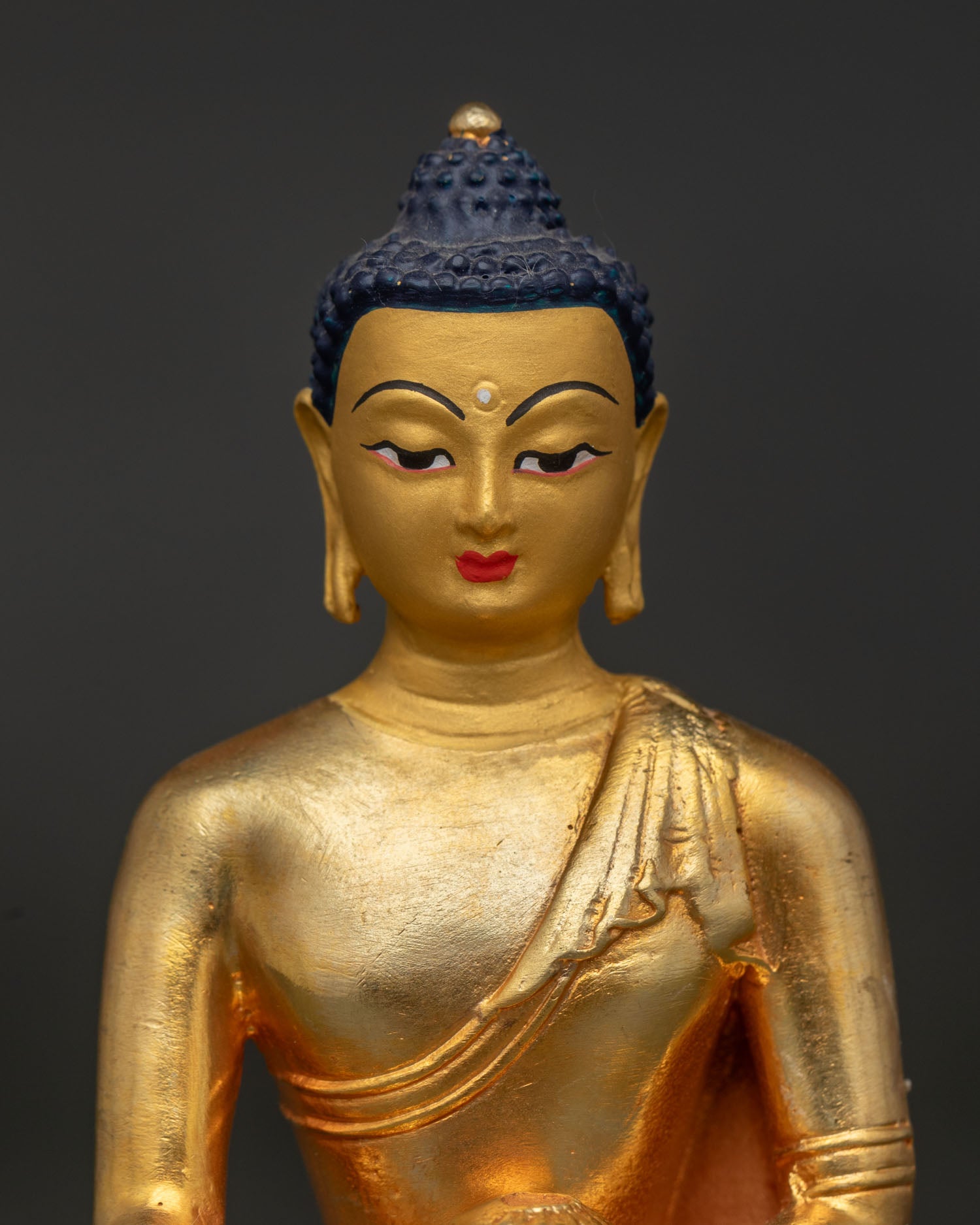Shakyamuni Buddha statue with gold fire gilded finish and painted face.