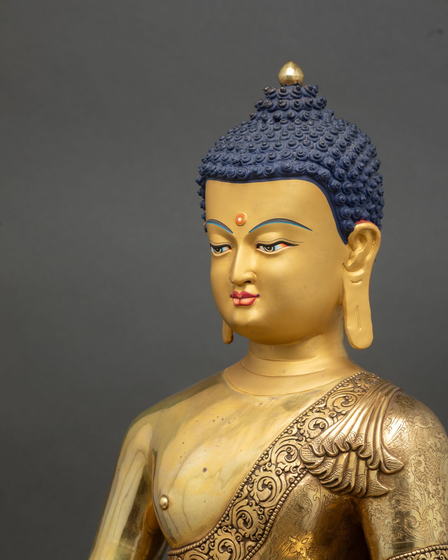 Side close up Amitabha Buddha statue ornate halo floral engraving copper gold finish