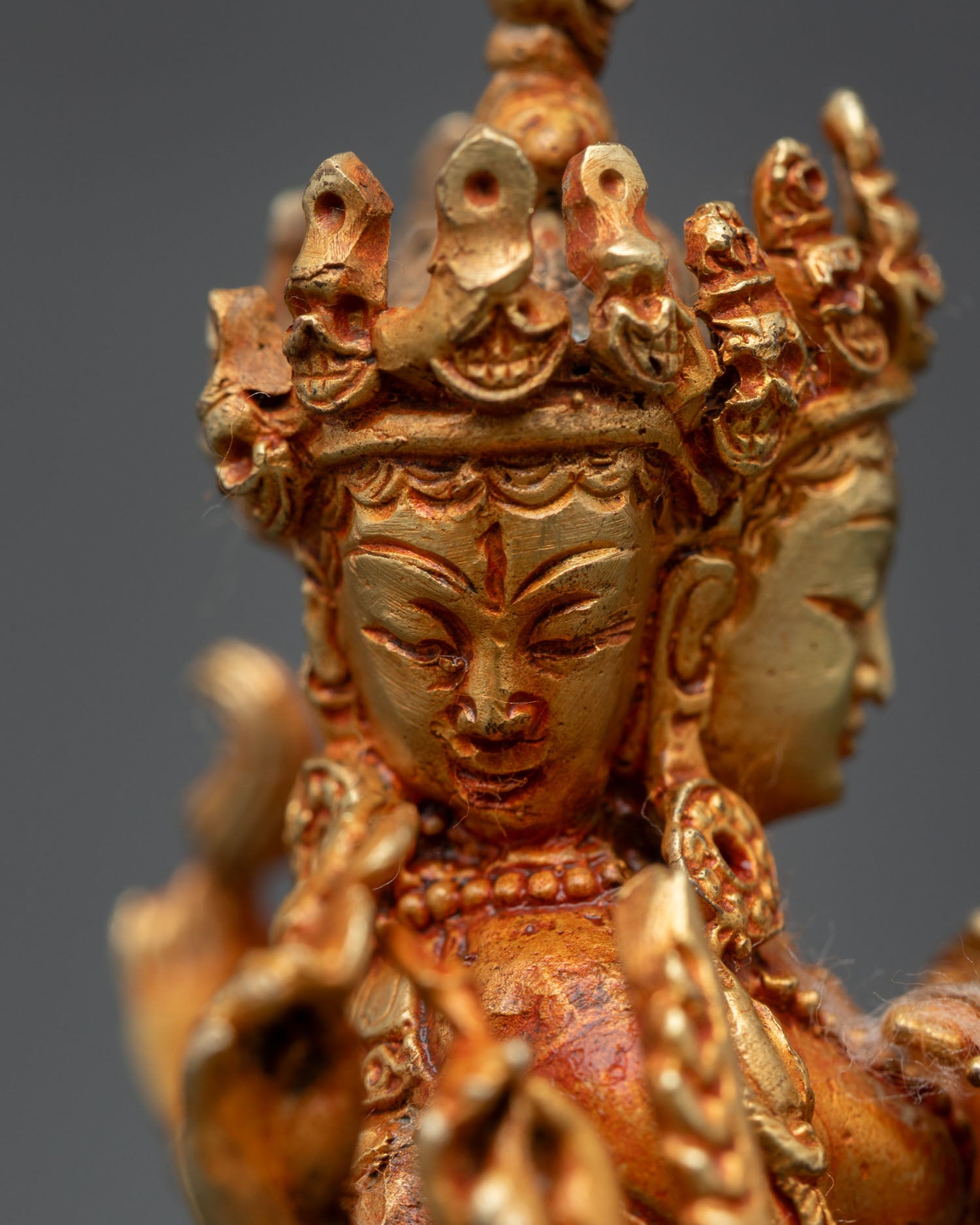 side close up marichi statue copper gold multi arm sacred attributes