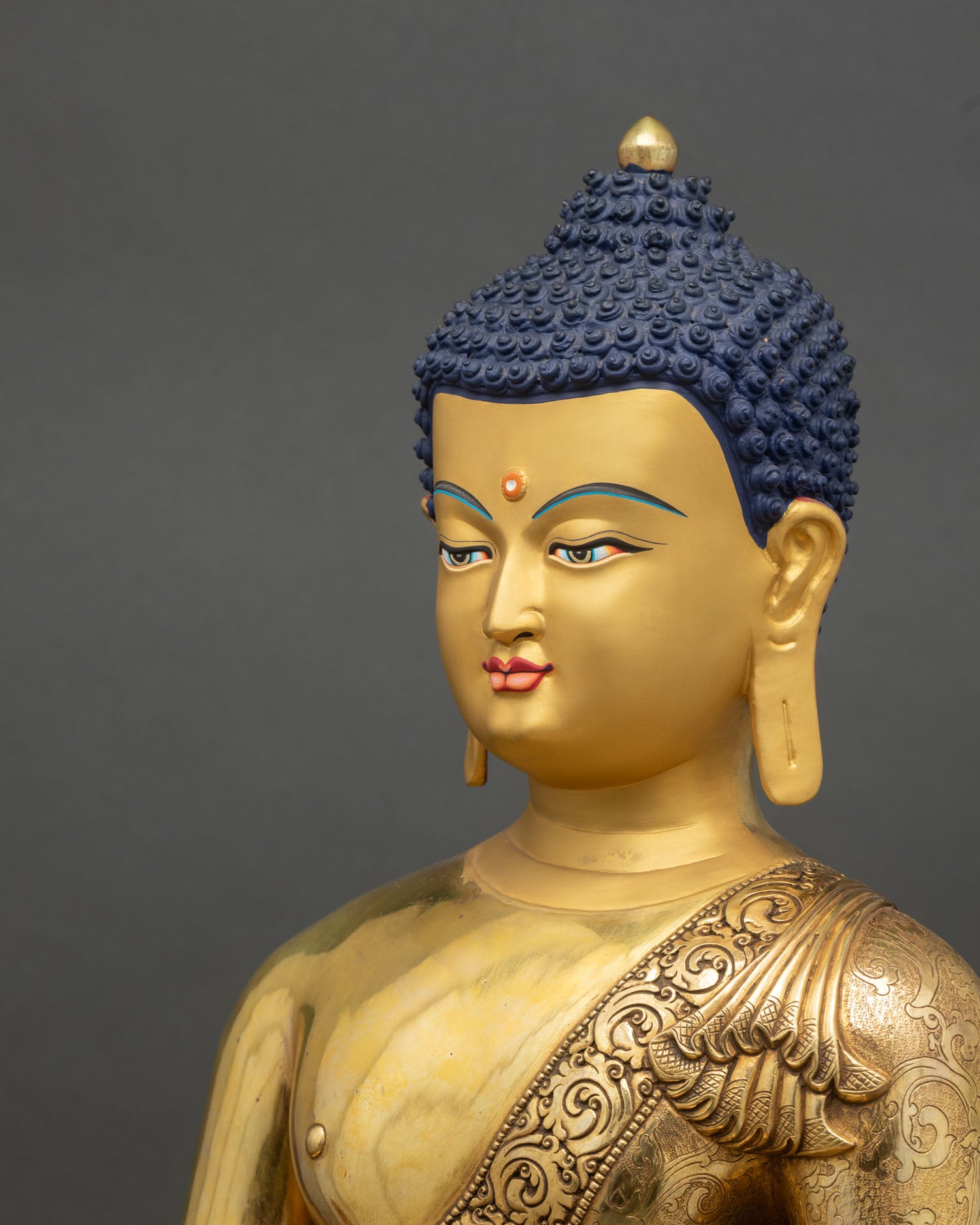 Side close up Medicine Buddha statue floral robe detail halo copper gold craftsmanship