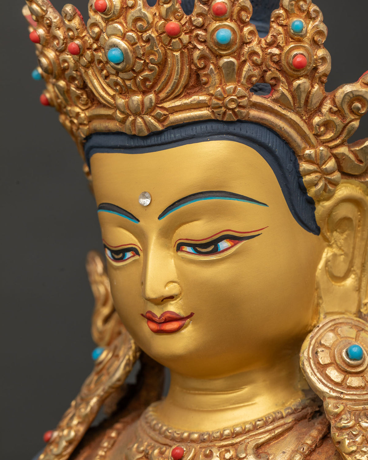 Side Close Up Of Amitayus Face Showing Gold Paint And Ornate Jewelry