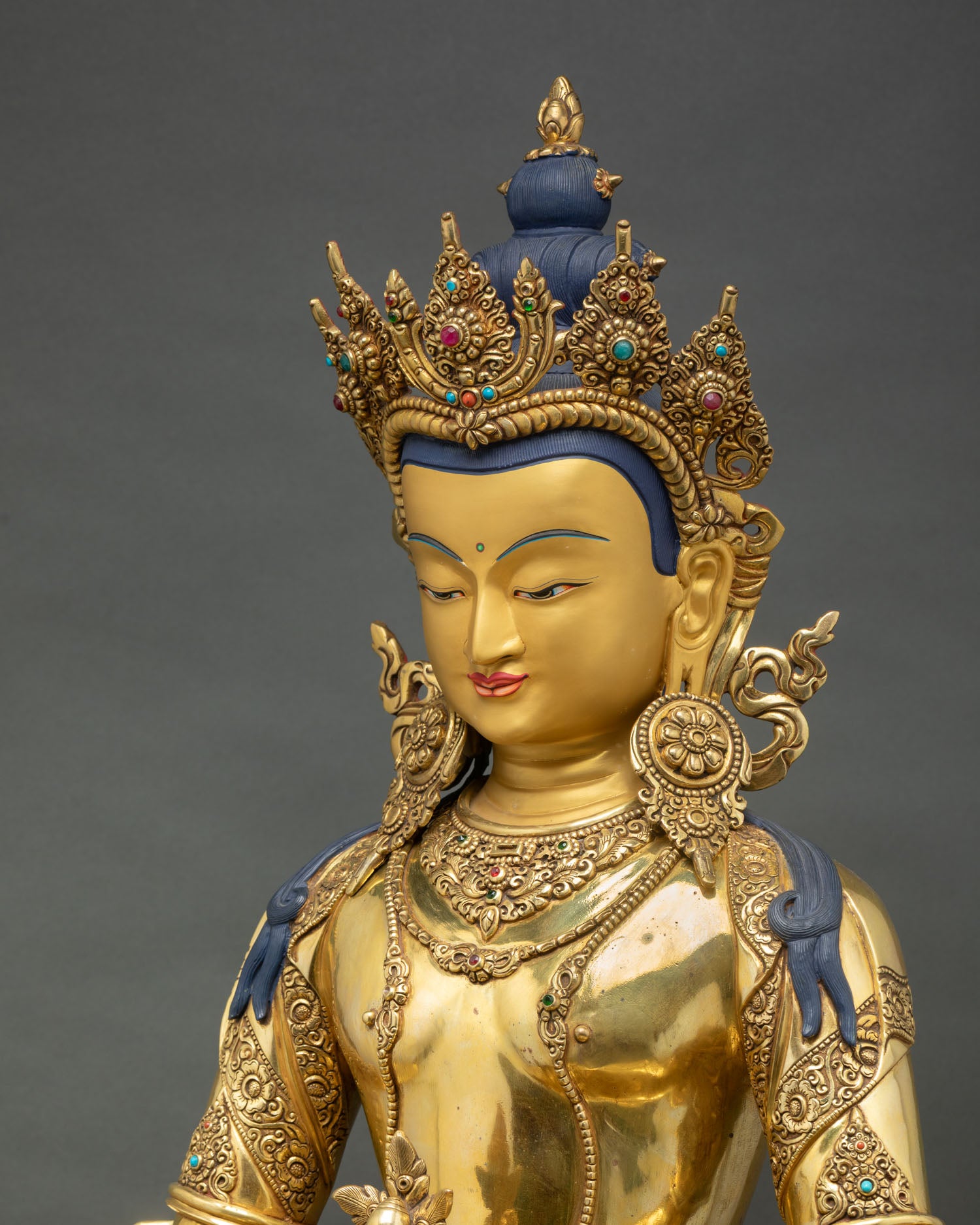 side close up of amitayus statue, intricate carvings, layered ornaments and lotus base craftsmanship