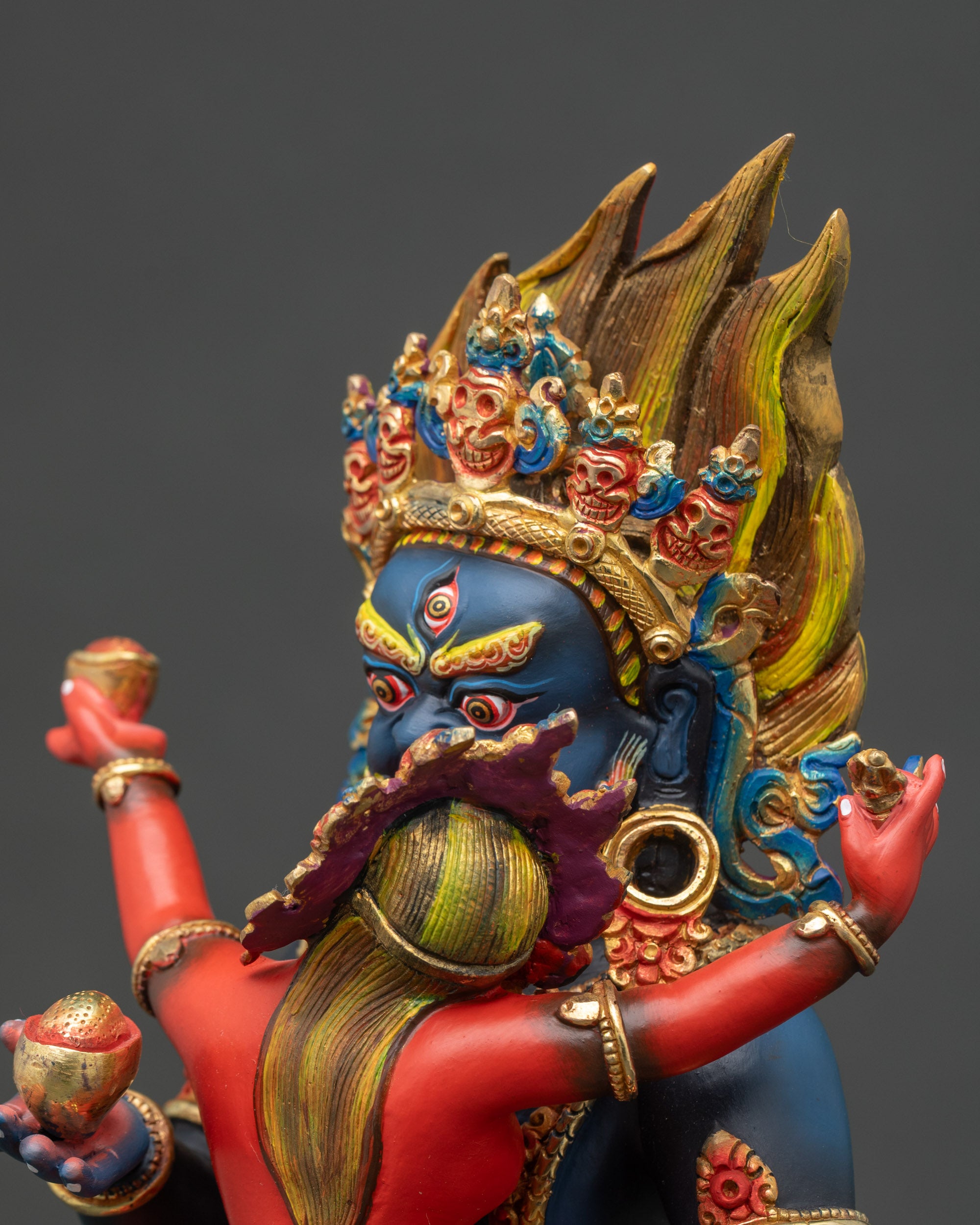 Side close-up of Black Dzambhala Yab Yum statue with lotus throne and vibrant acrylic colors
