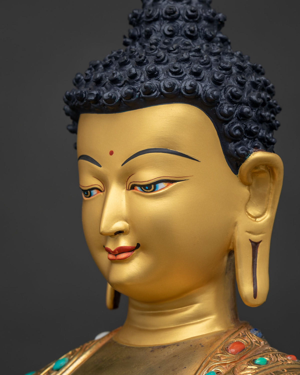 Side close-up of Buddha face with polished 24K gold fire-gilded finish