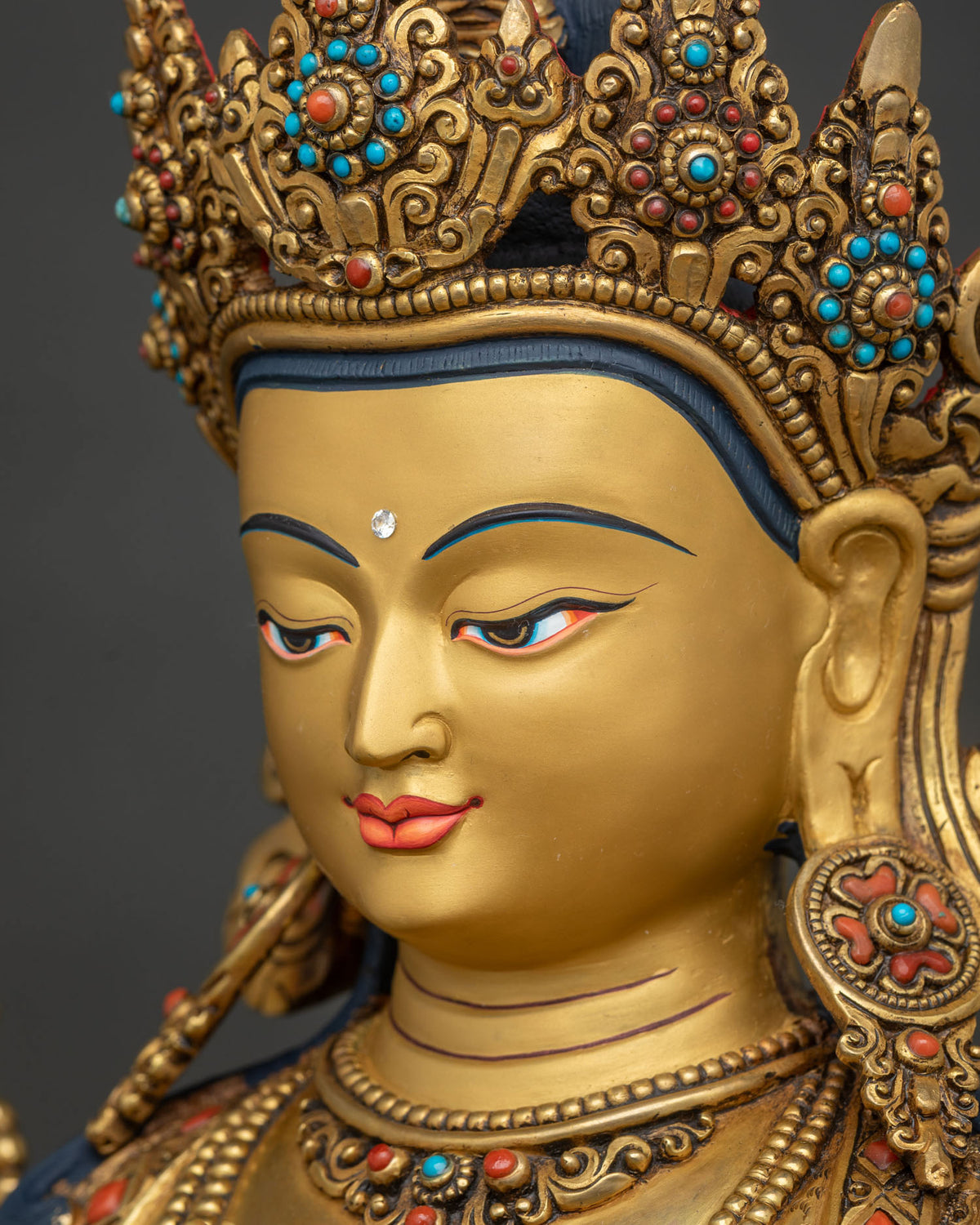 Side close-up of Chenrezig face with polished 24K gold fire-gilded finish