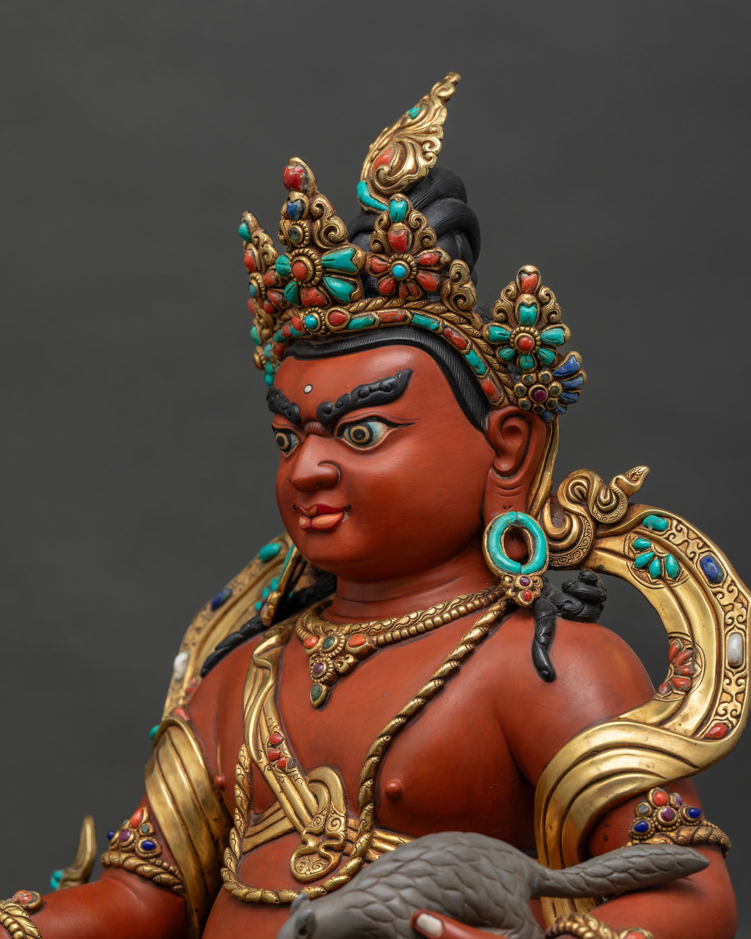Side close-up of Dzambhala Statue showing repousse work and semi-precious stone inlay