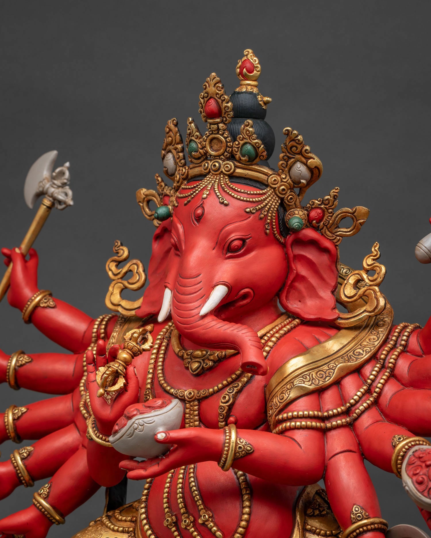 Side Close-Up of Ganesh Idol's Arms Holding Ritual Implements