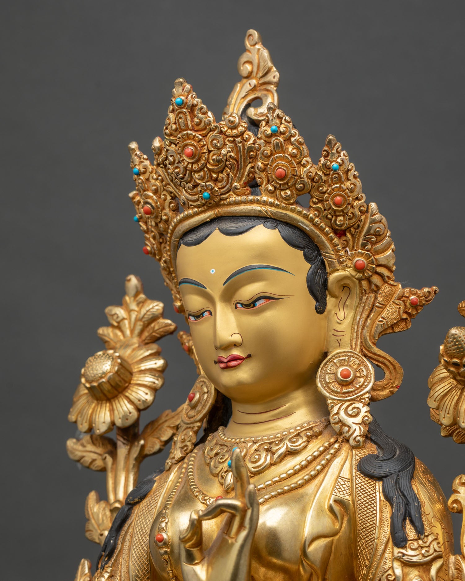 Side close-up of Green Tara statue with detailed robes and semi-precious stone jewelry