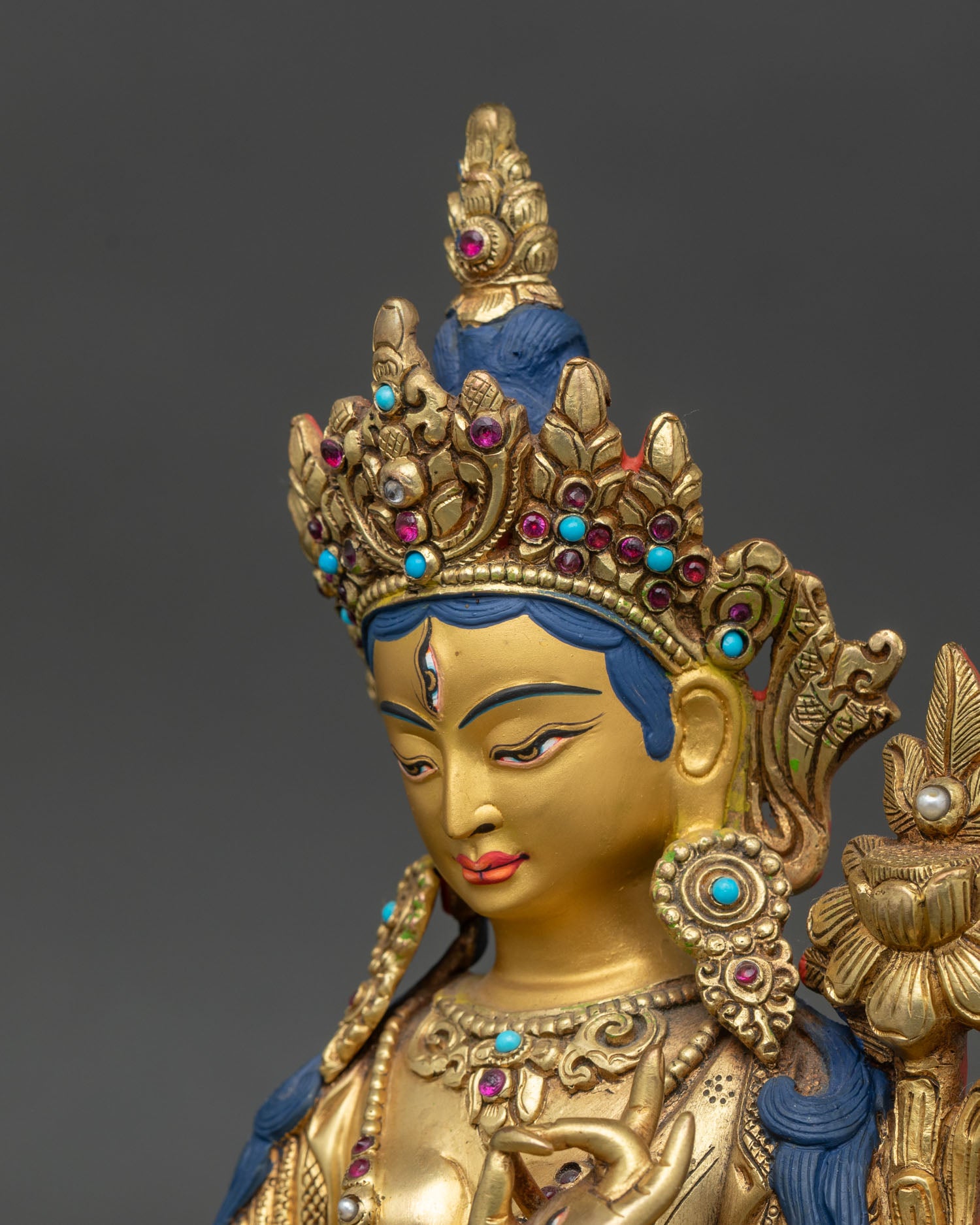 Side close-up of White Tara statue highlighting lotus and hand-set semi-precious stones