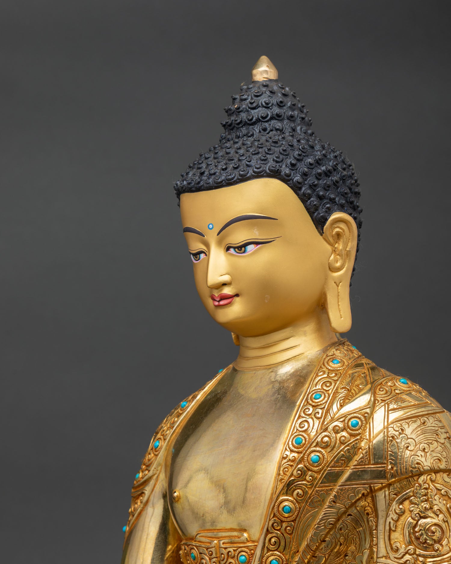 side close up shakyamuni buddha statue, engraved robe details, turquoise inlay copper gold