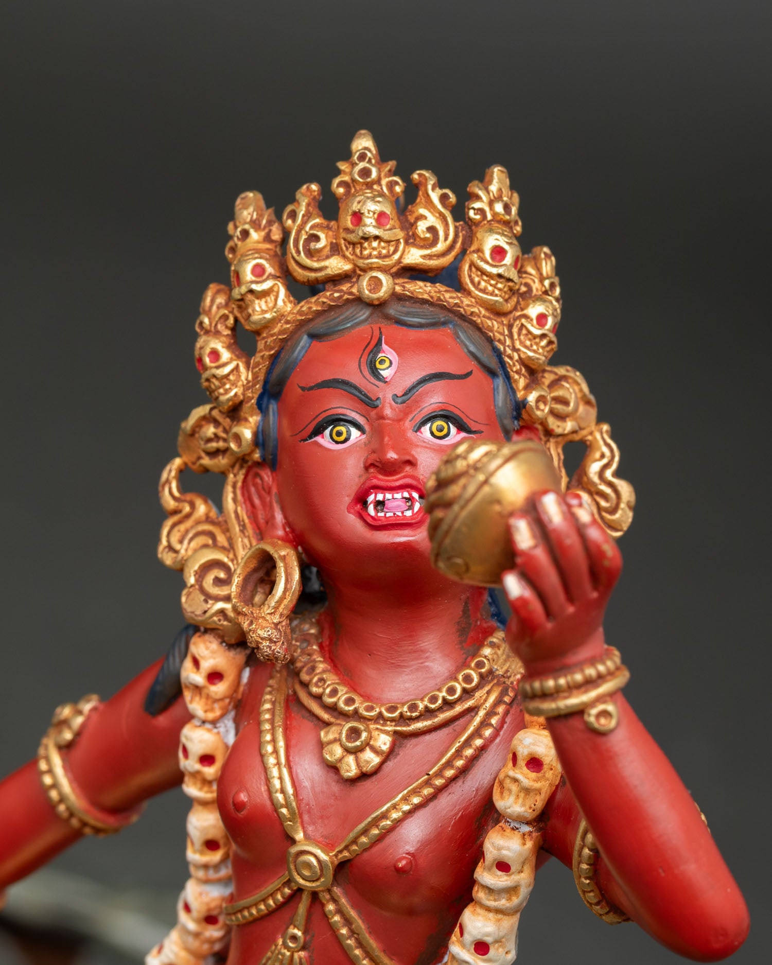 Side detail Vajrayogini statue showing curved knife, skull cup, gold gilded copper and ritual ornaments