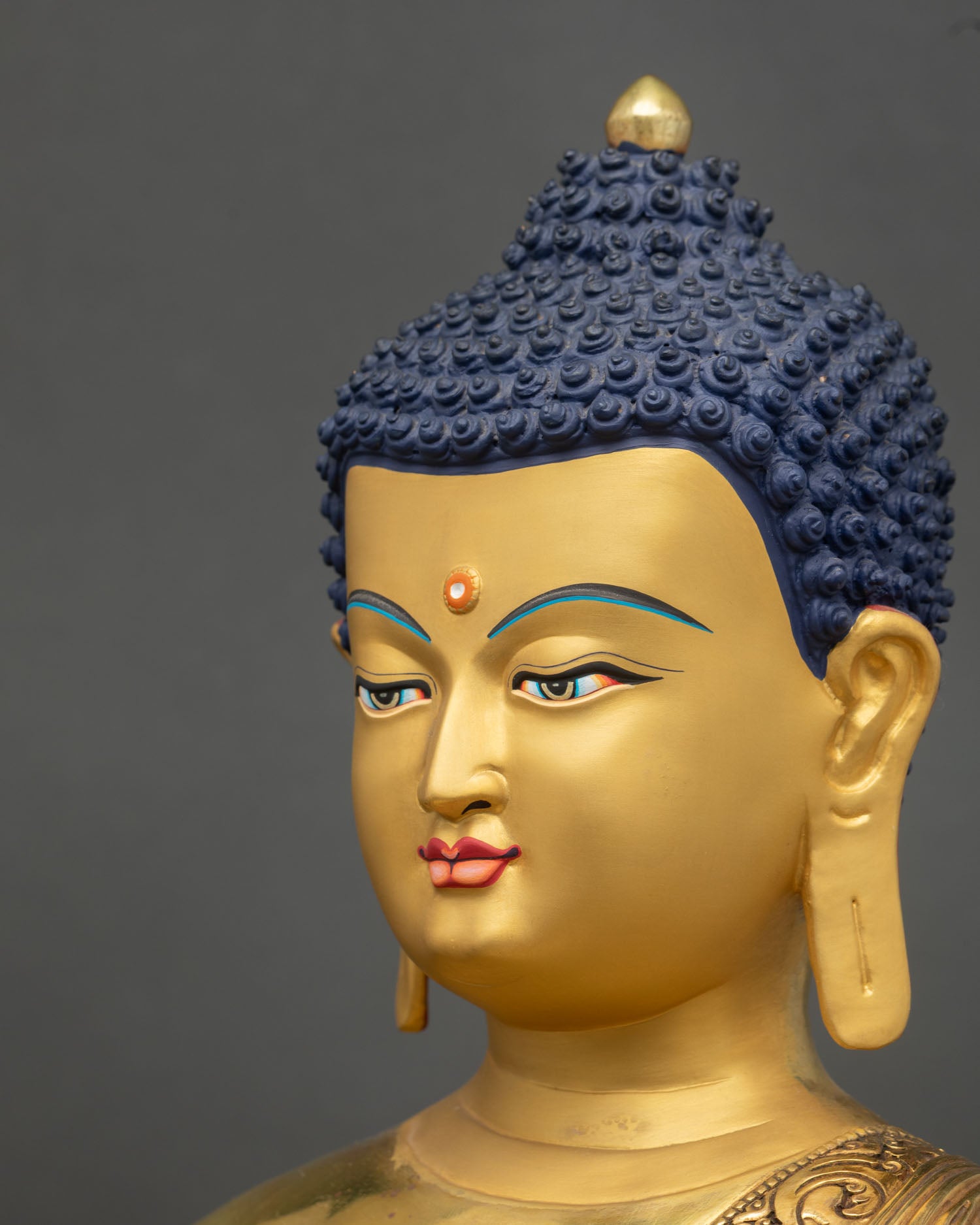 Side face close up Medicine Buddha peaceful expression intricate gold Buddhist art Nepal