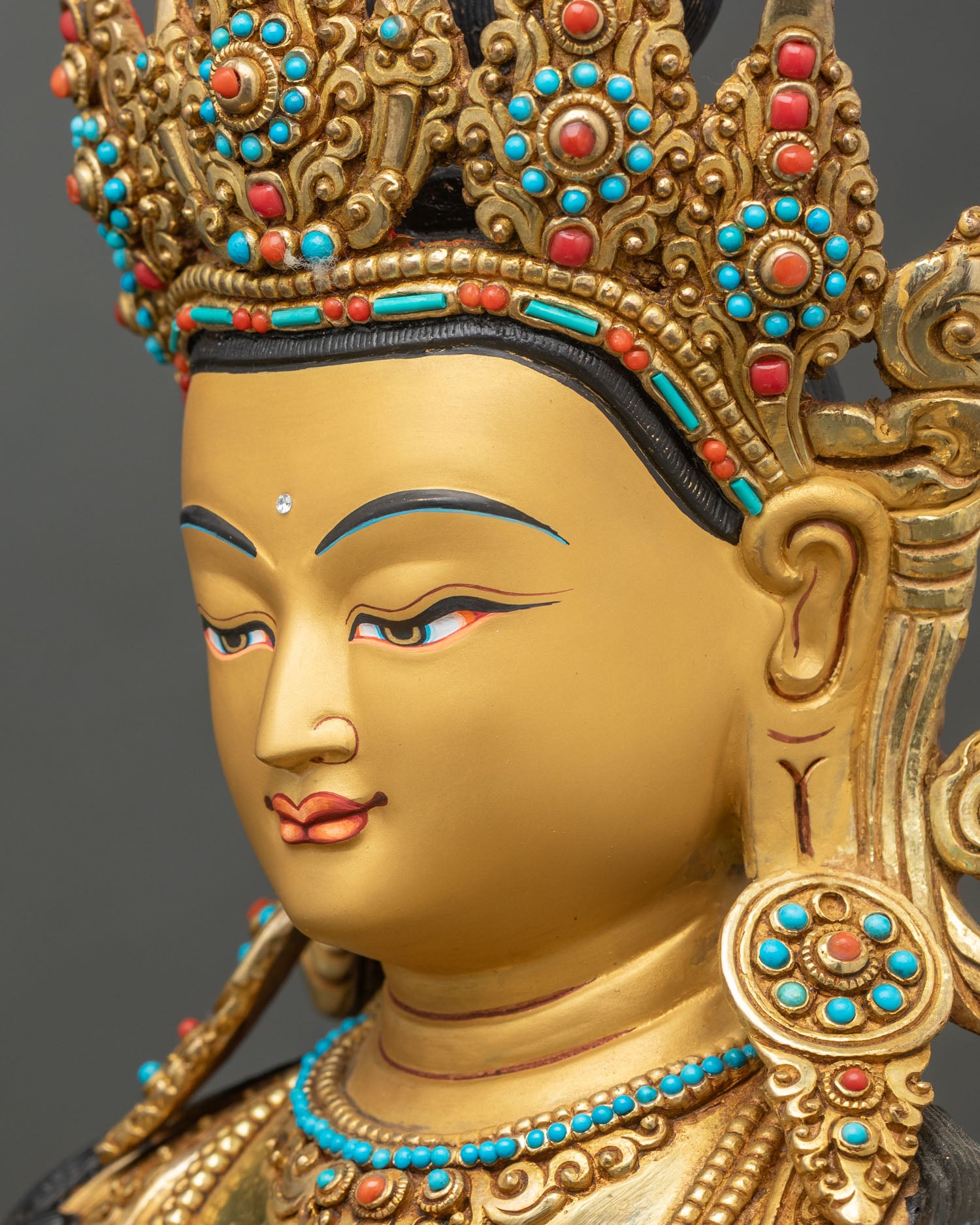 Side face close-up of Amitayus Buddha with hand-painted gold features and calm expression