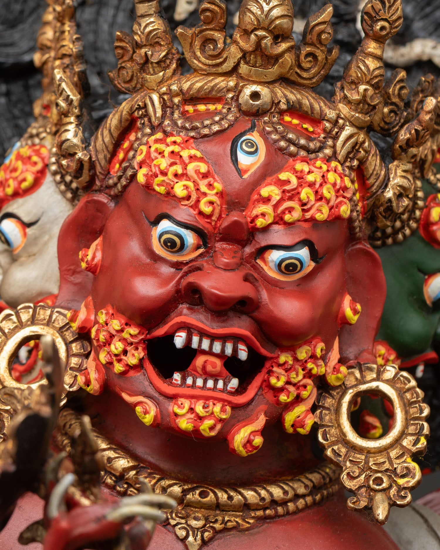 side face close up of hayagriva with expressive features, gold gilding and detailed headdress