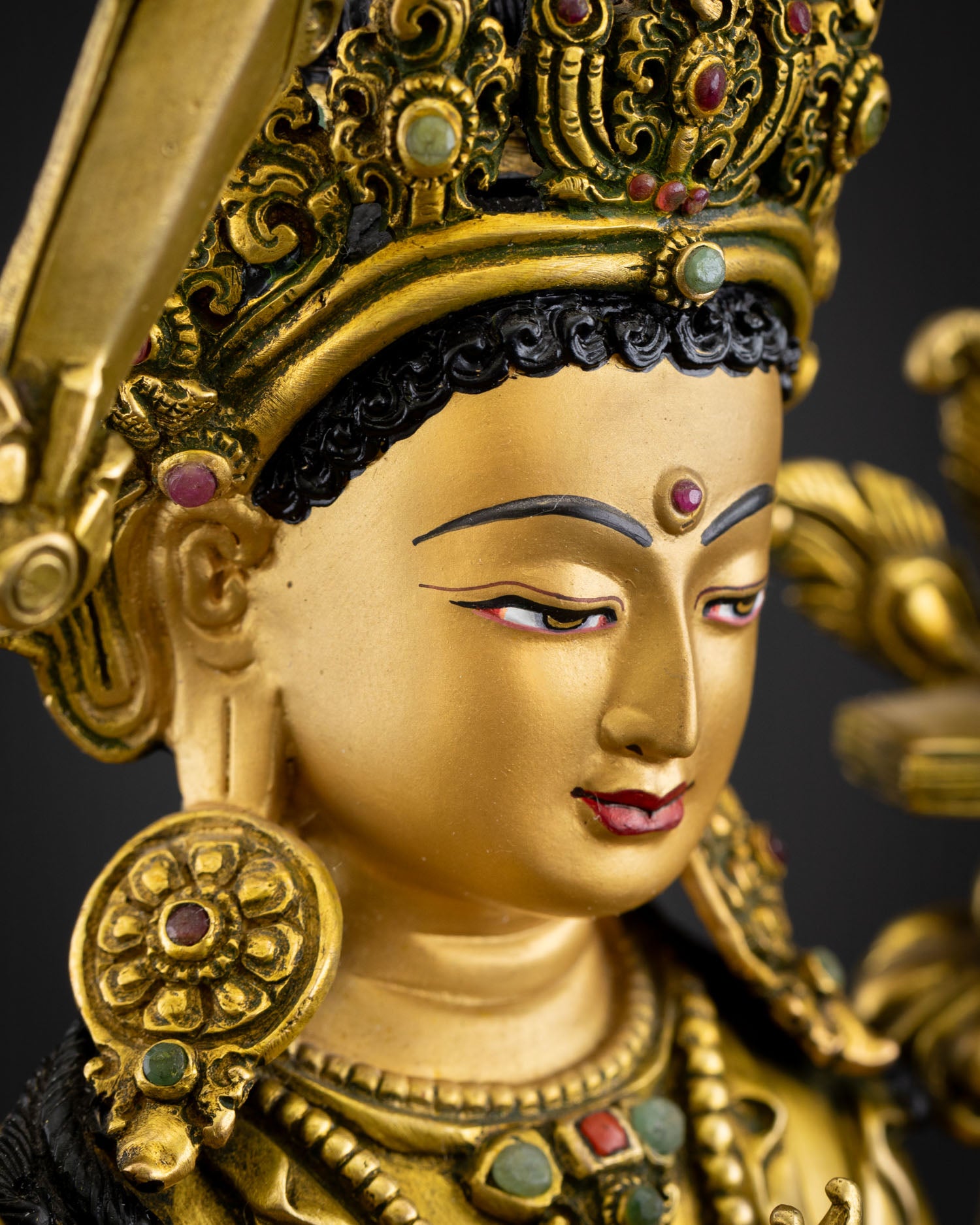 Side face close-up of Simhanada Manjushri with intricate gold detailing