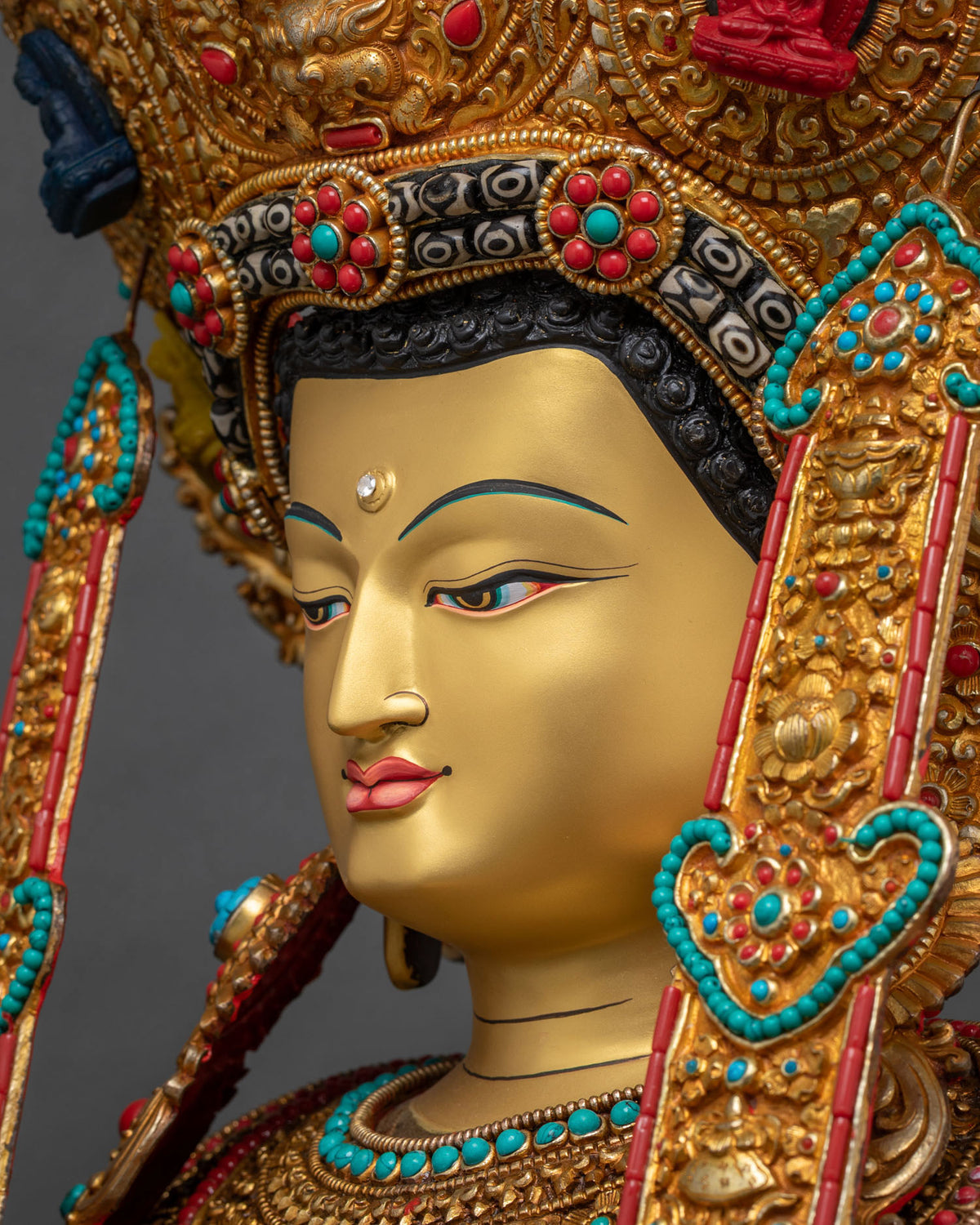Side profile close up of Jowo Rinpoche's golden face and jeweled crown