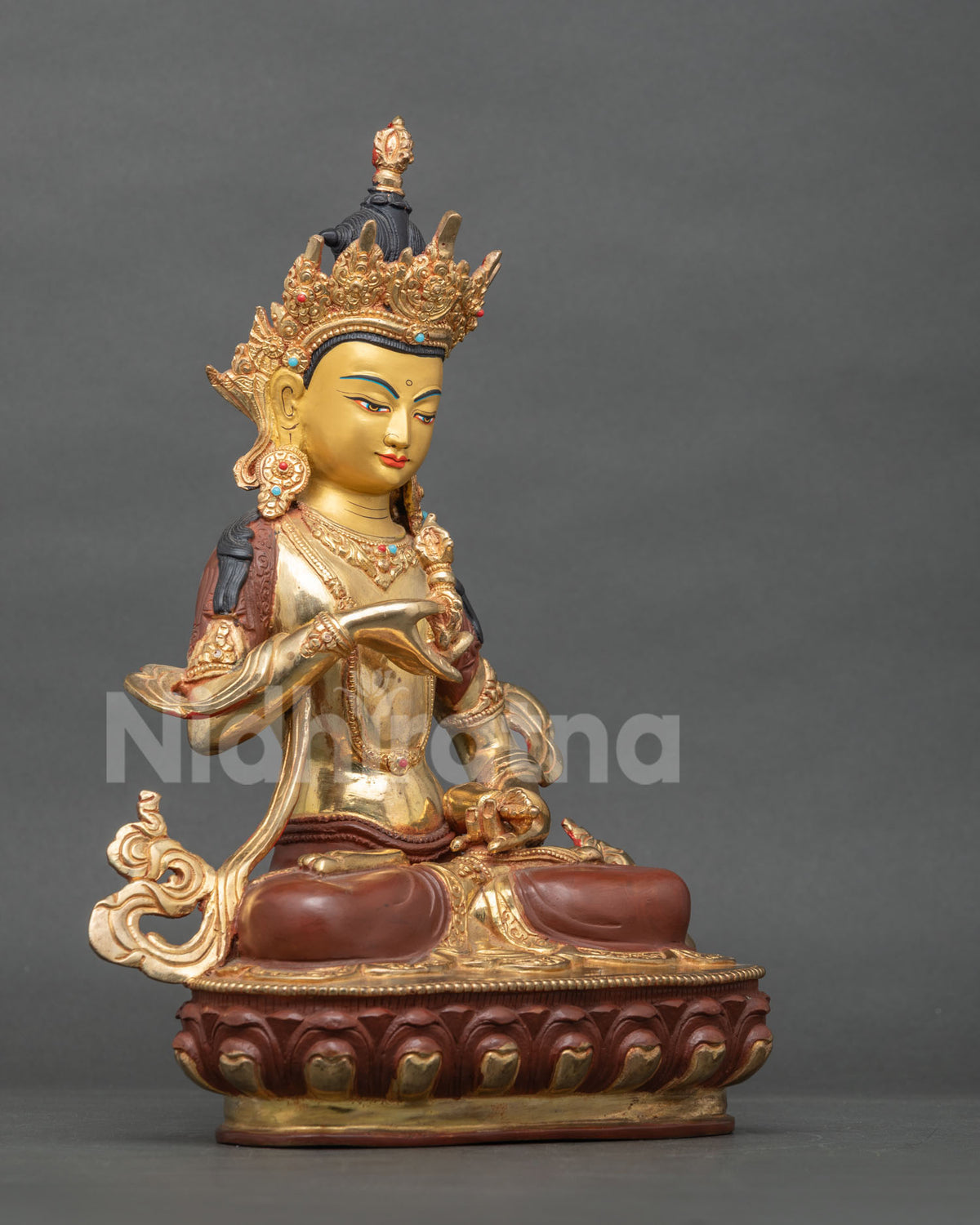 Side profile of handmade Vajrasattva Buddha statue seated on lotus pedestal with ornate crown
