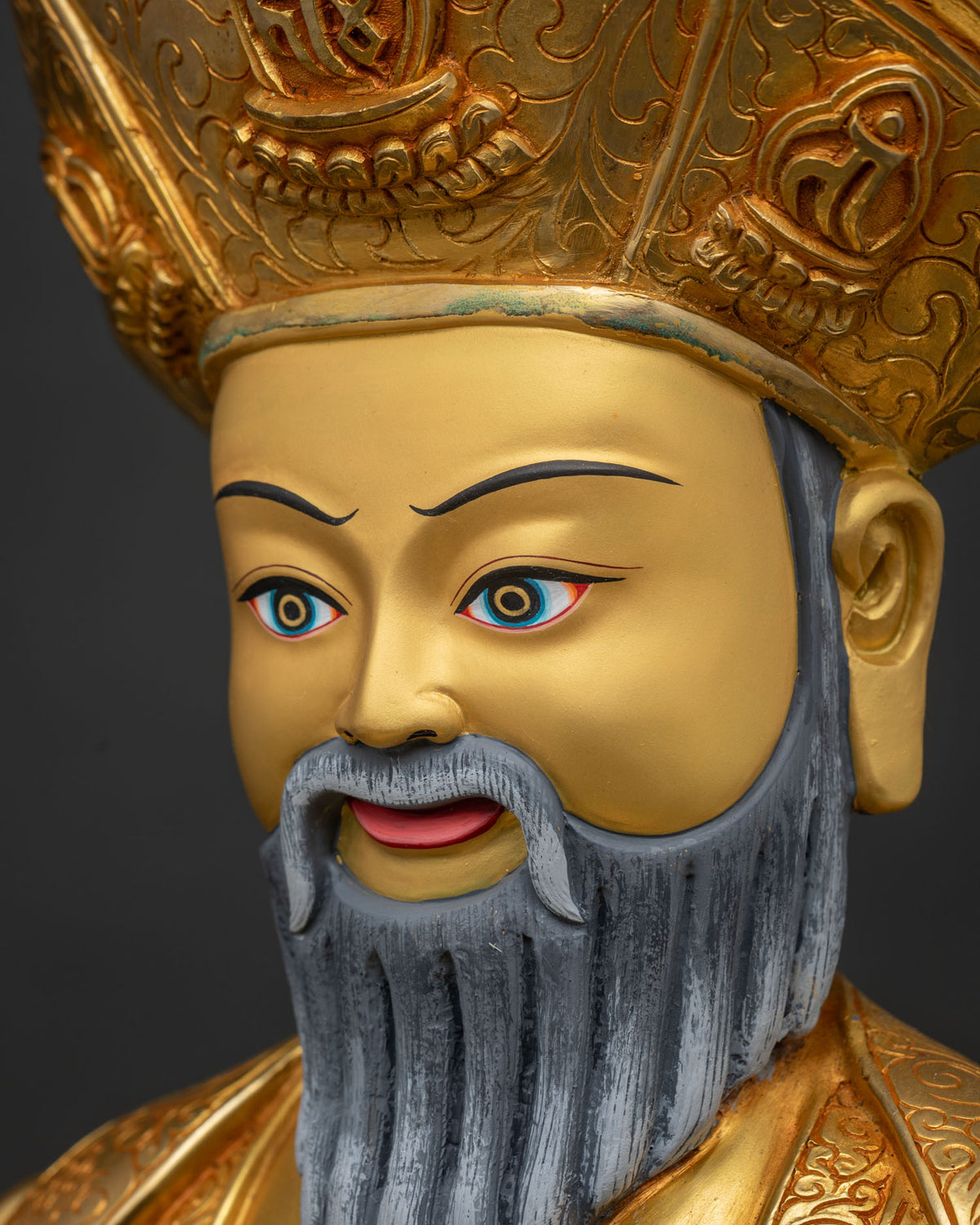 Side profile of Ngawang Namgyal's gilded face, beard and lama crown detail