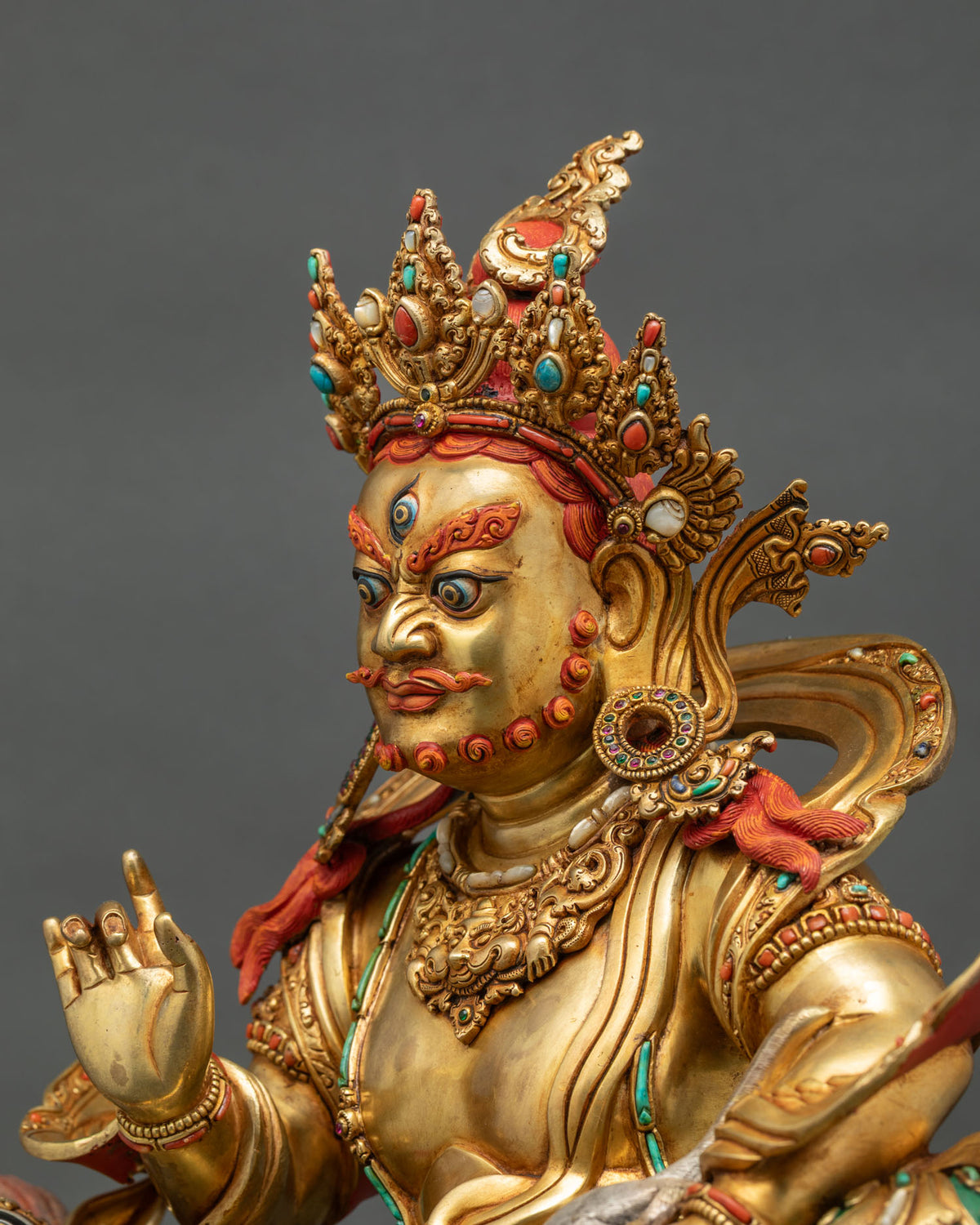Side profile of Vaishravana statue face with jeweled crown, hand-painted details, Nepal