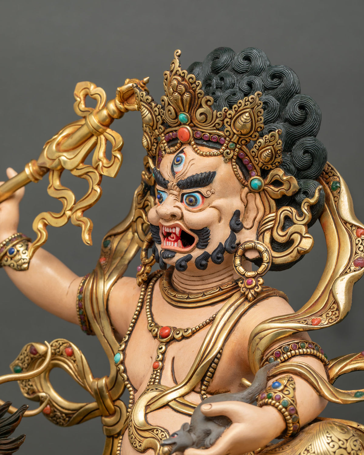 Side profile of White Dzambhala holding a ritual scepter, with jeweled crown and gold-gilded details