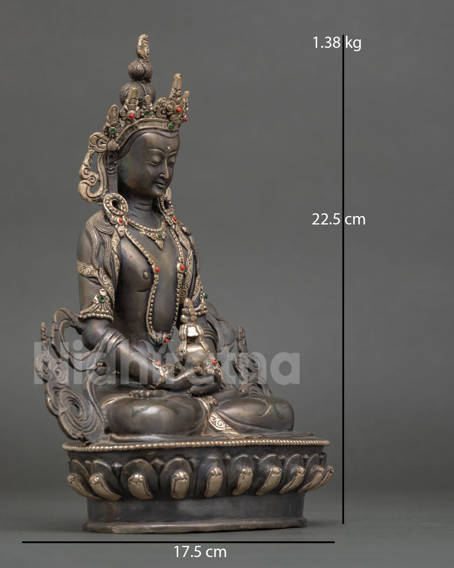 Side view of Amitayus statue in meditative posture on carved lotus throne highlighting copper oxidized texture silver plated accents