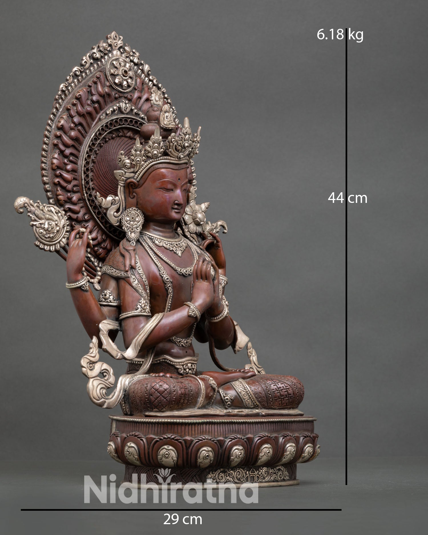 Side view of Avalokiteshvara compassion deity statue with lotus pedestal and Himalayan detailing