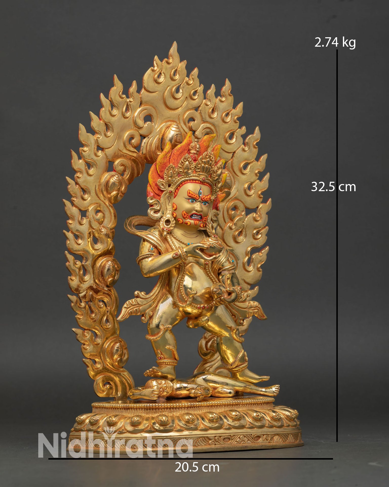 Side view of Black Dzambhala holding mongoose skull cup, traditional sculpture from Nepal