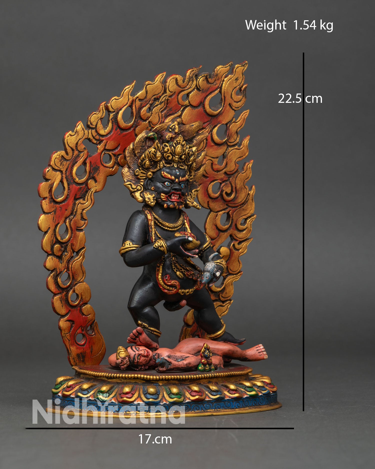 Side view of Black Dzambhala statue Himalayan Buddhist wealth god seated lotus throne subduing negativity flaming aura