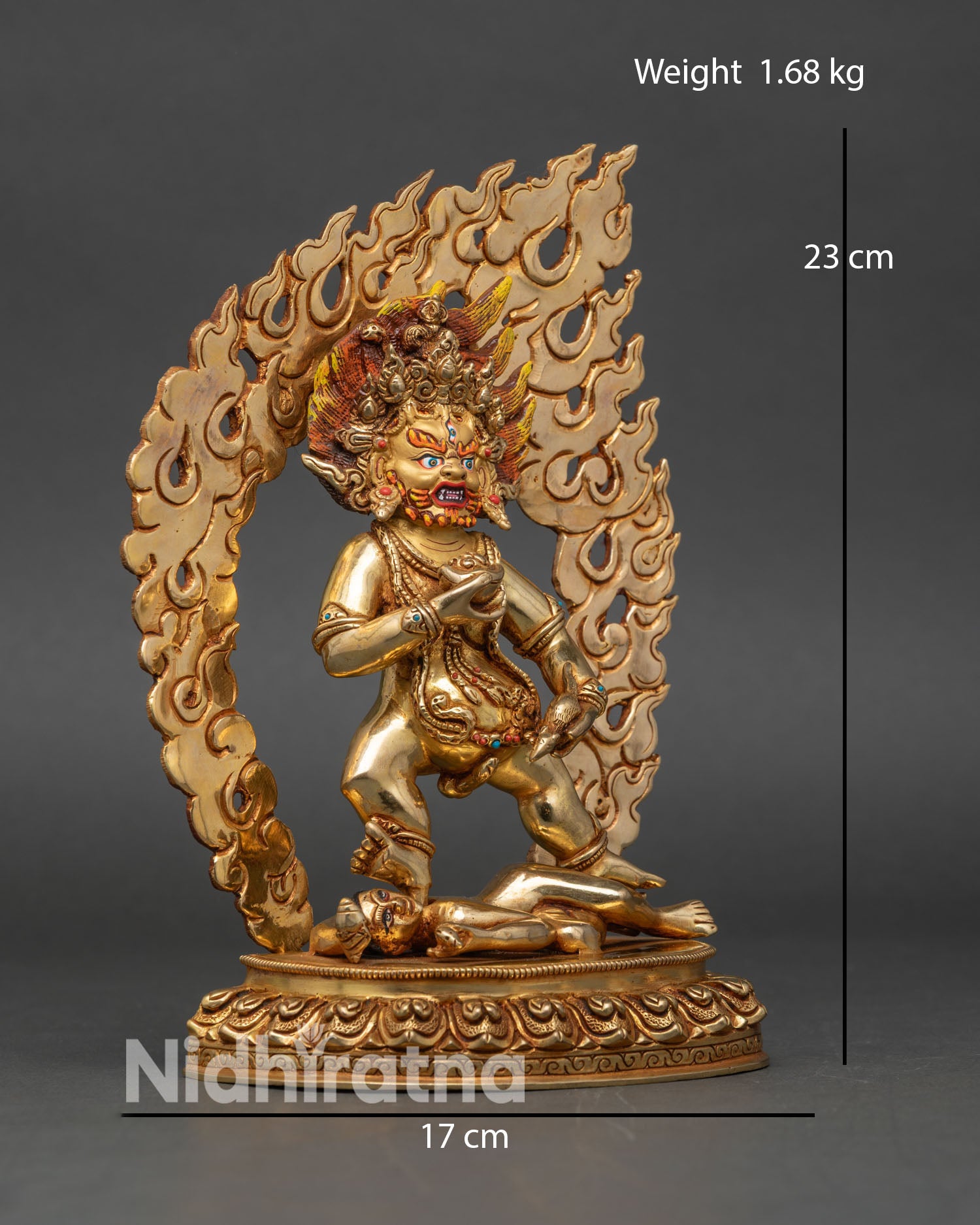 Side view of Black Dzambhala wrathful form holding mongoose of wealth and skull cup copper statue Nepal sacred art