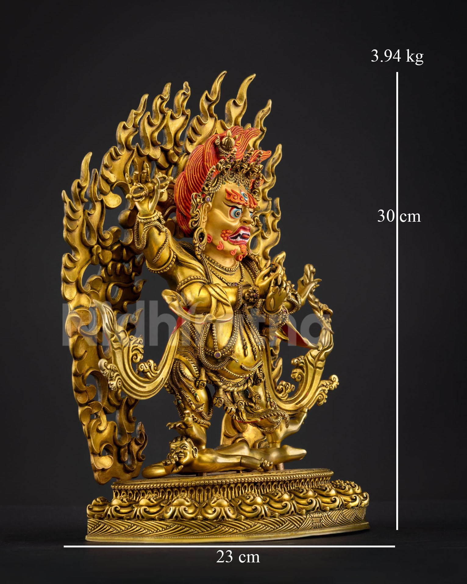Side view of Four-Armed Vajrapani statue wrathful deity standing lotus base subdued figure fire halo copper fire gilded Buddhist protector art from Nepal
