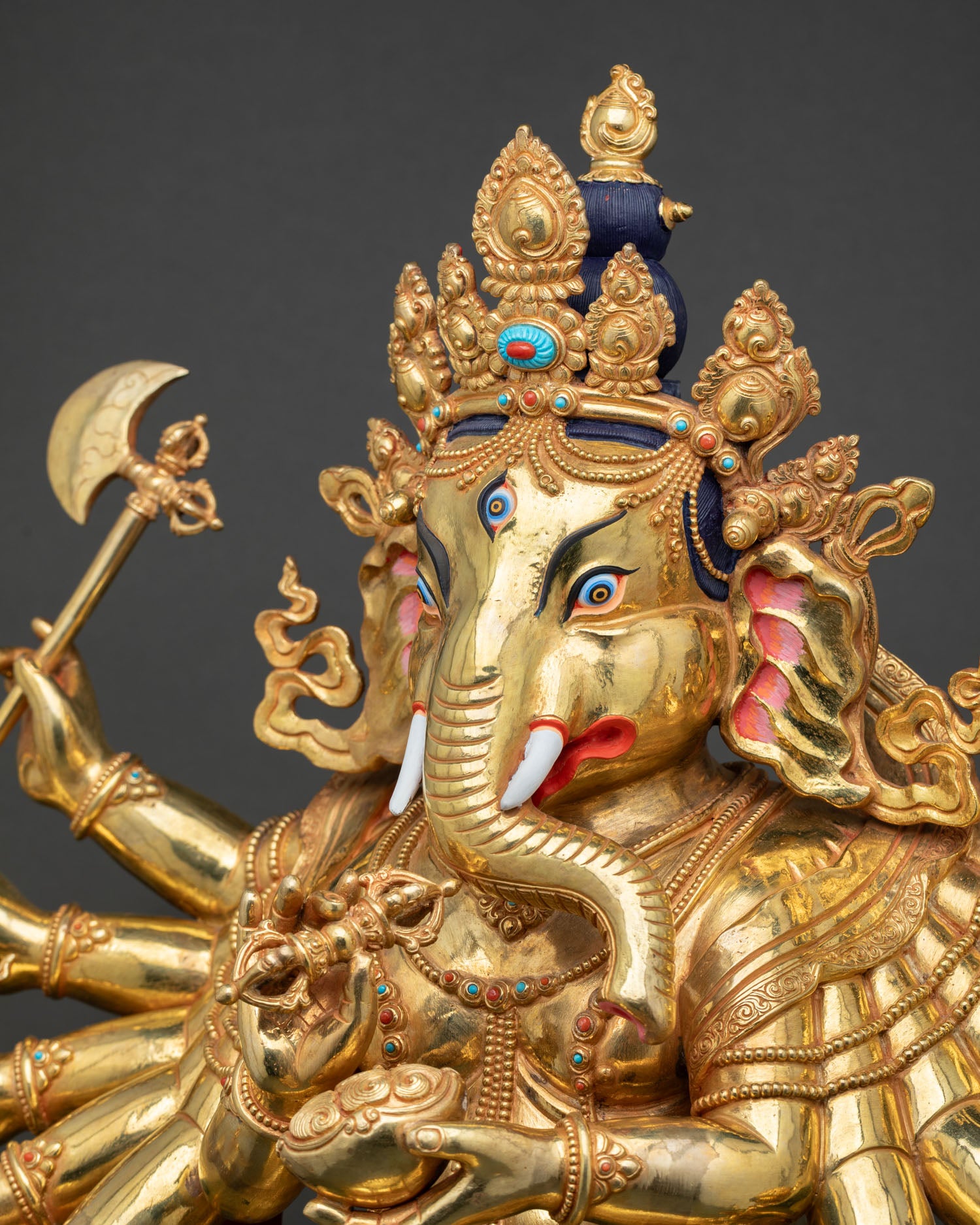 Side view Ganesh statue head with vajra kapala and elephant ear detail