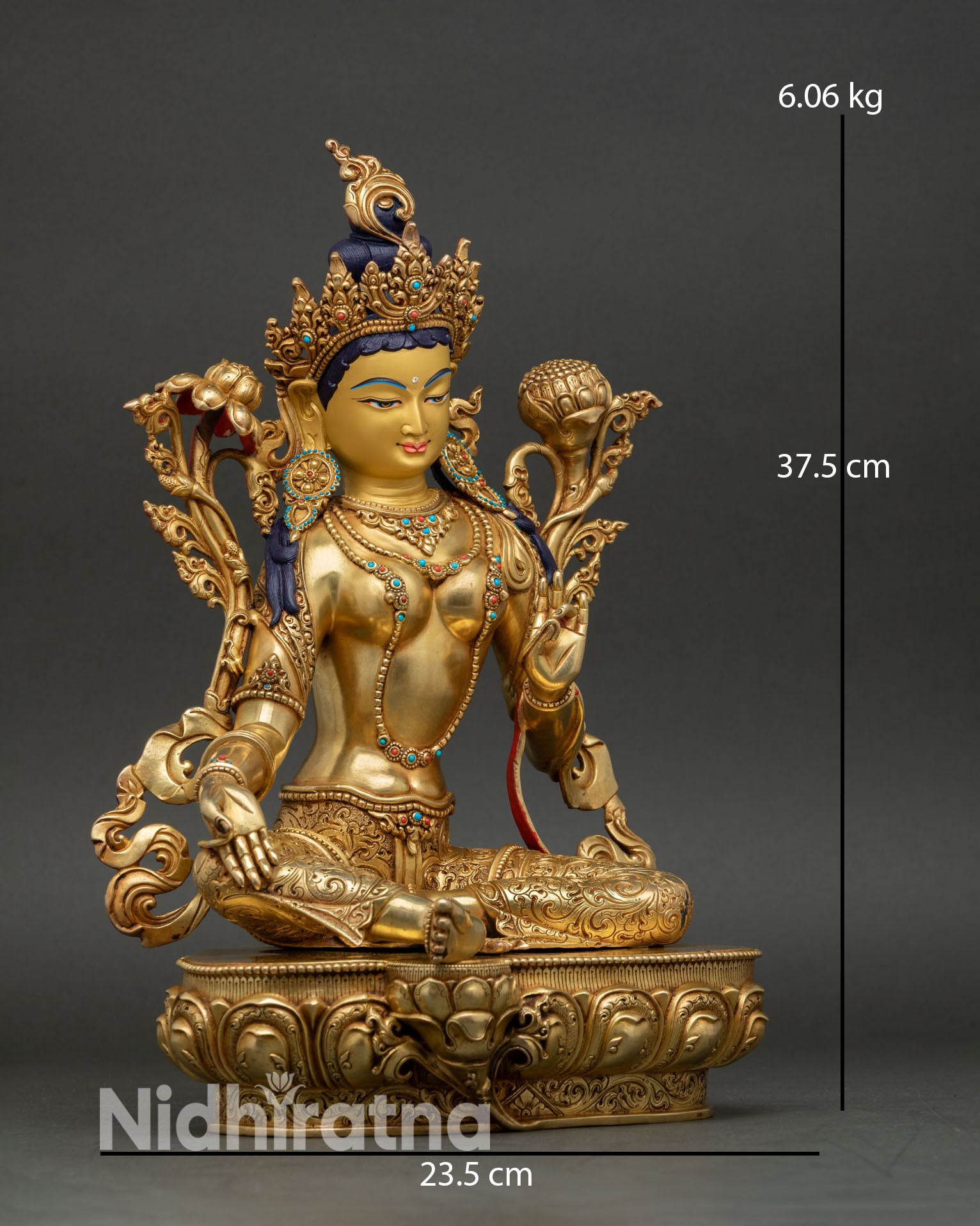 Side view Green Tara Buddhist sculpture seated posture with flowing ornaments.