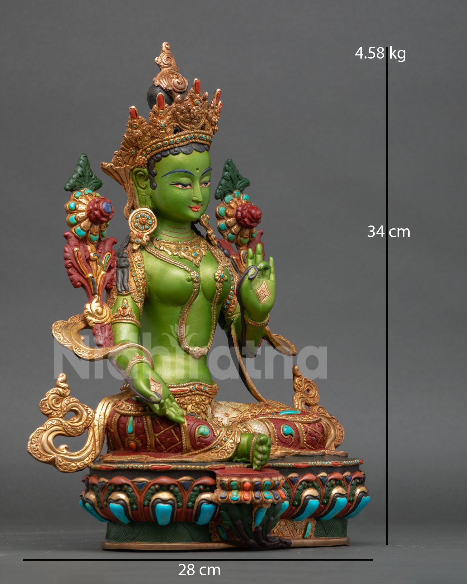 Side view of Green Tara goddess statue on double lotus throne holding utpala flower with sacred symbolism