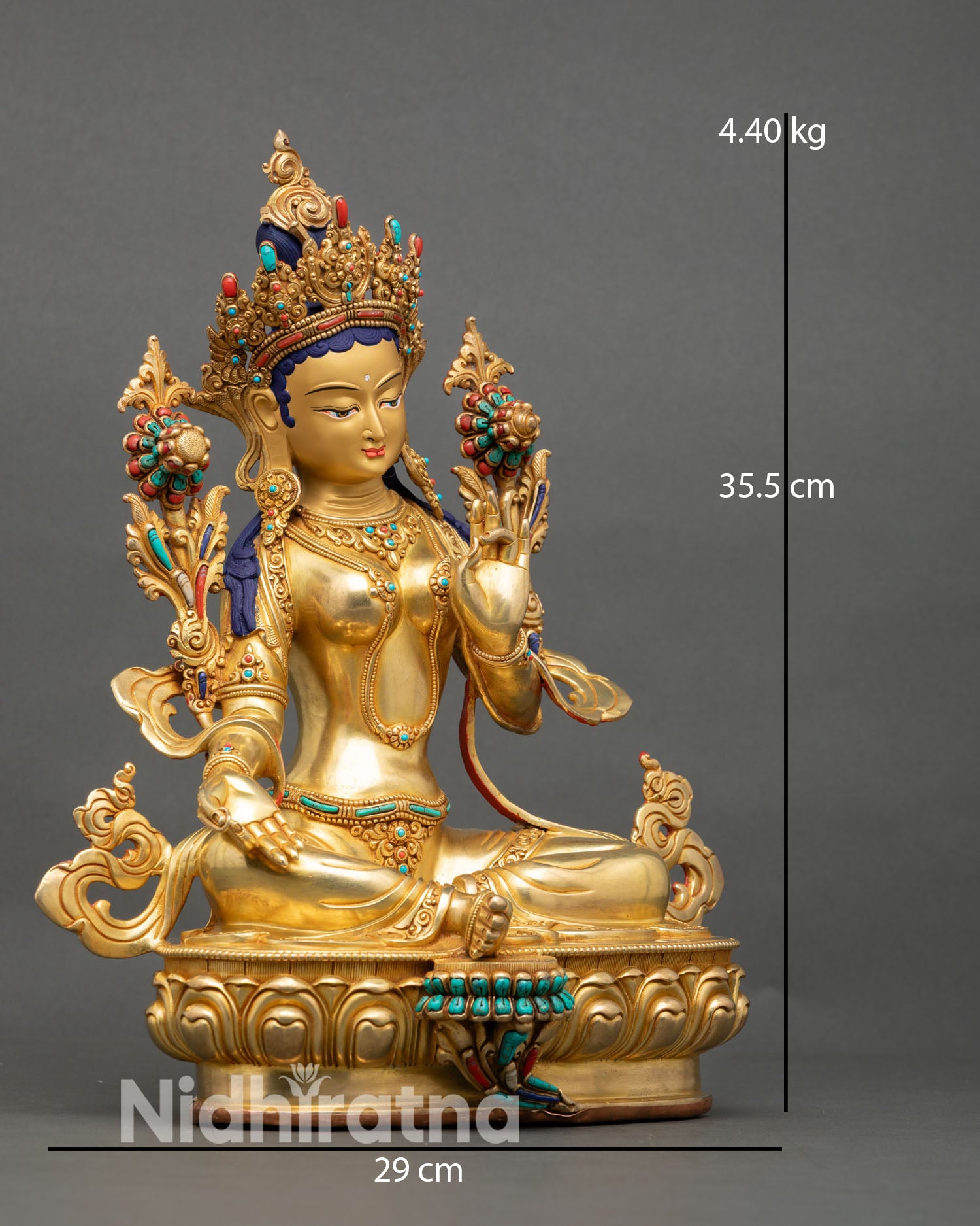 Side view of Green Tara statue active posture extended right foot lotus blossoms symbolic compassion and protection Nepal copper sculpture