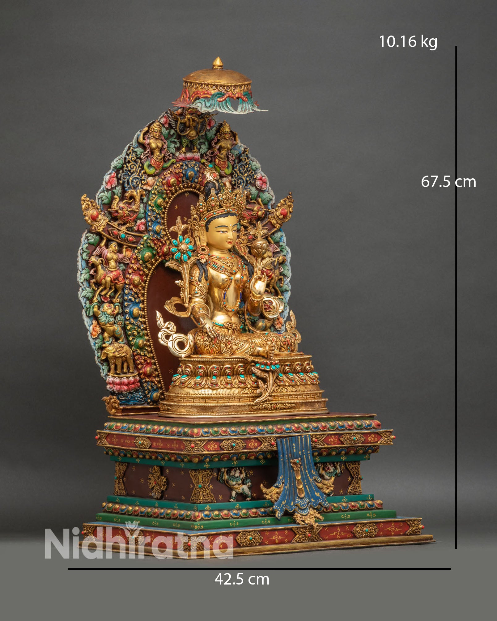 Side view of Green Tara statue with lotus seat and ornate hand-painted throne