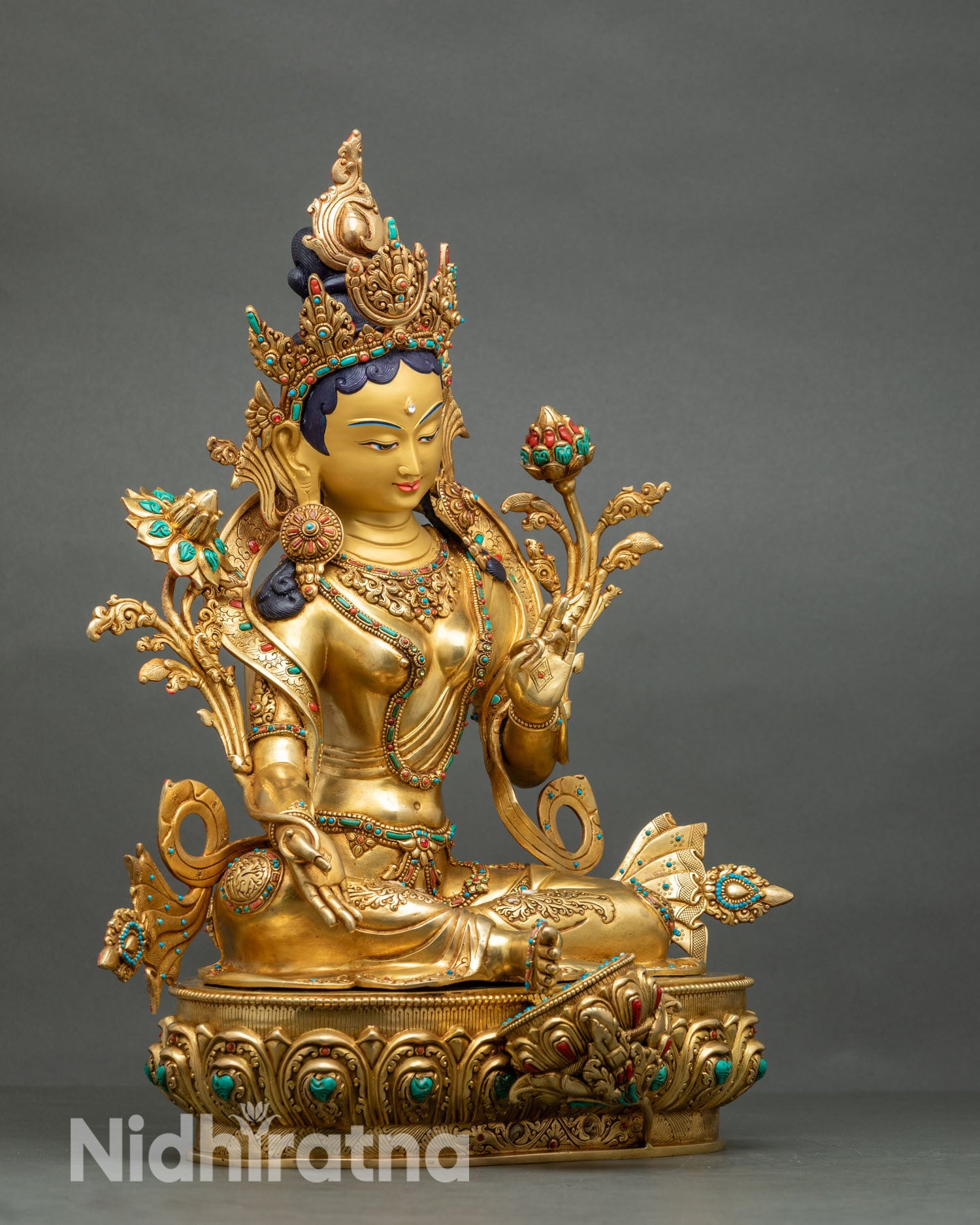 Side view Green Tara statue, seated lotus pose, varada mudra, abhaya mudra, spiritual sculpture Nepal