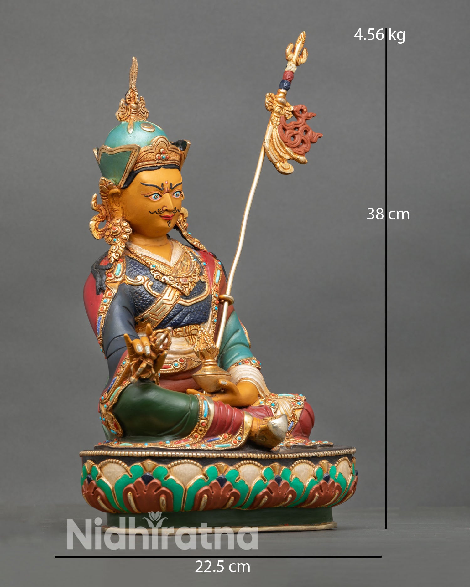 Side view of Guru Rinpoche statue, meditative posture, lotus throne, intricate floral motifs, copper Buddhist sculpture, Vajrayana sacred art, altar centerpiece
