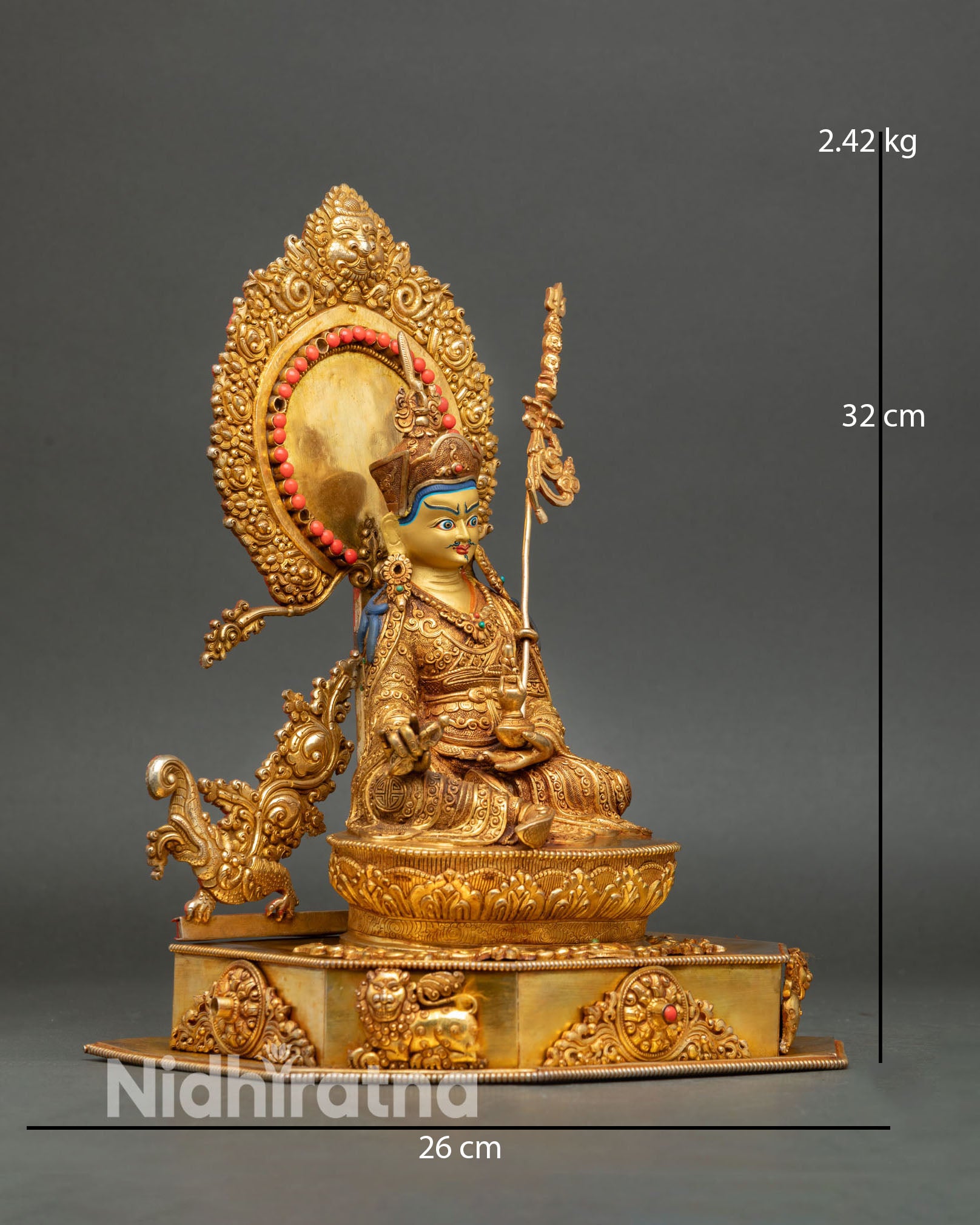 Side view of Guru Rinpoche statue showing ornate throne design with turquoise and coral inlay set in a gold framework.