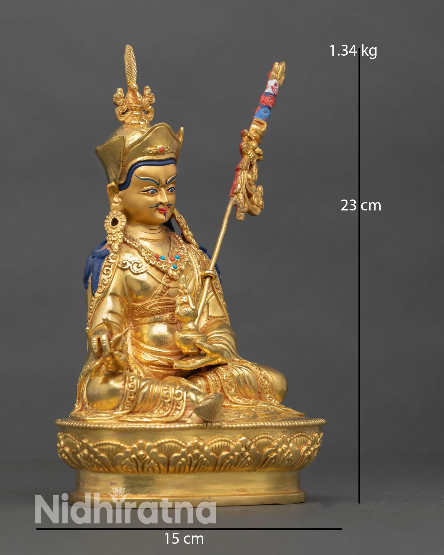 Side view of Guru Rinpoche statue showing khatvanga staff resting on shoulder lost wax copper casting Tibetan Buddhist ritual sculpture