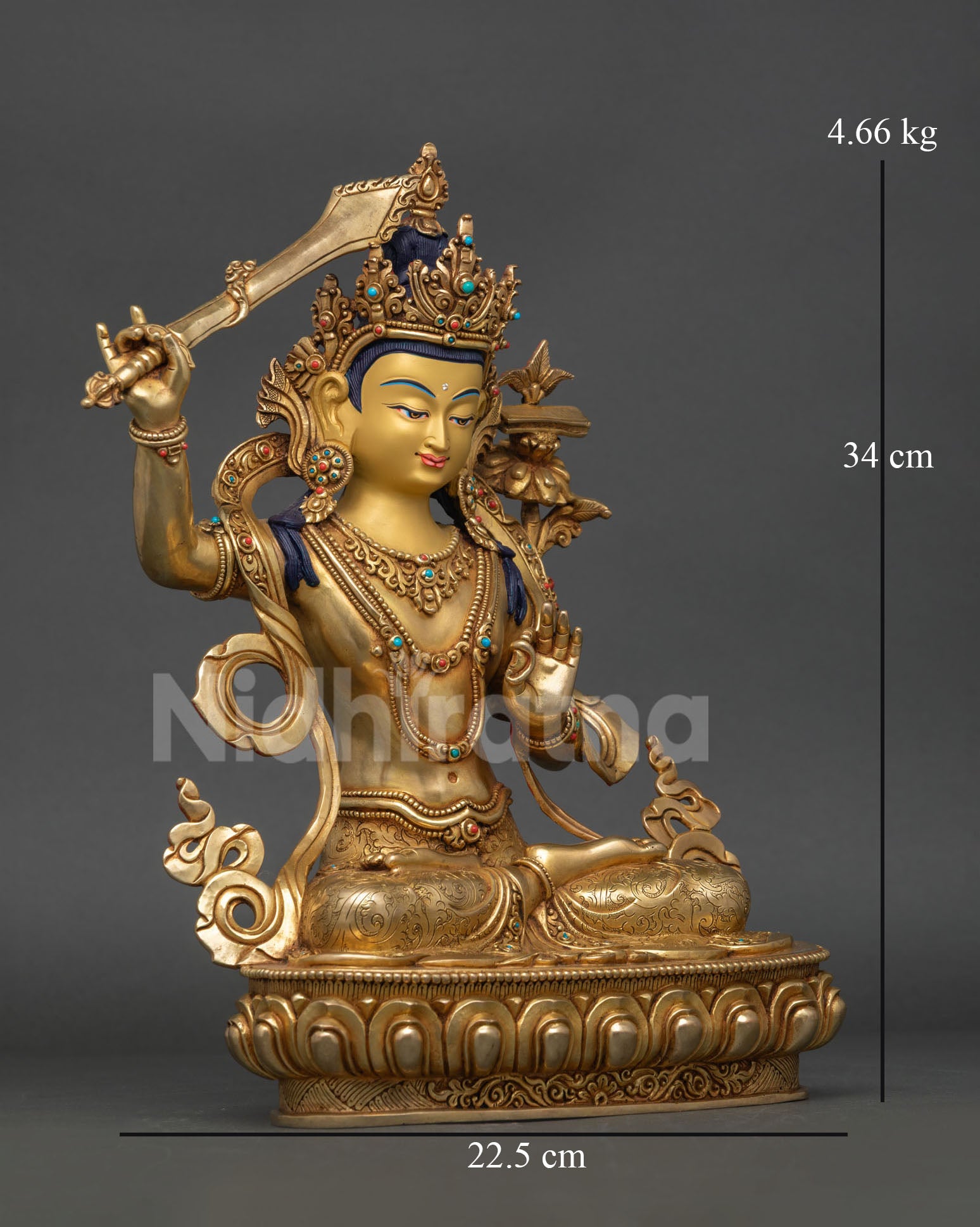 Side-view of Himalayan Manjushri sculpture, handcrafted Nepalese copper wisdom deity with utpala flower