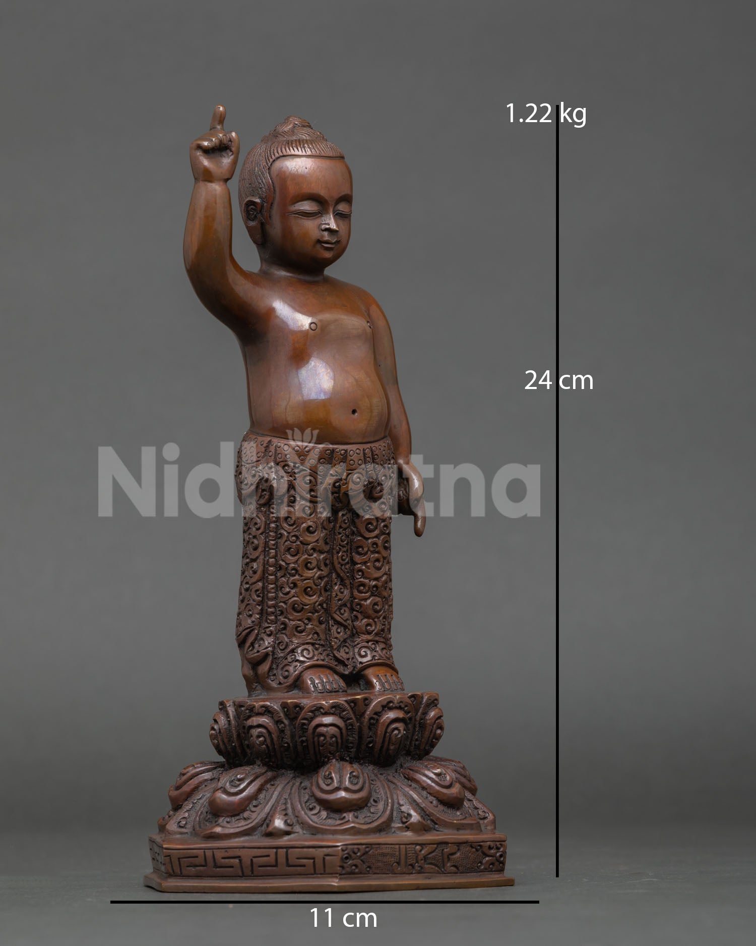 Side view of Little Buddha statue oxidized copper finish, details lotus pedestal traditional Nepal metal art spiritual awakening decor