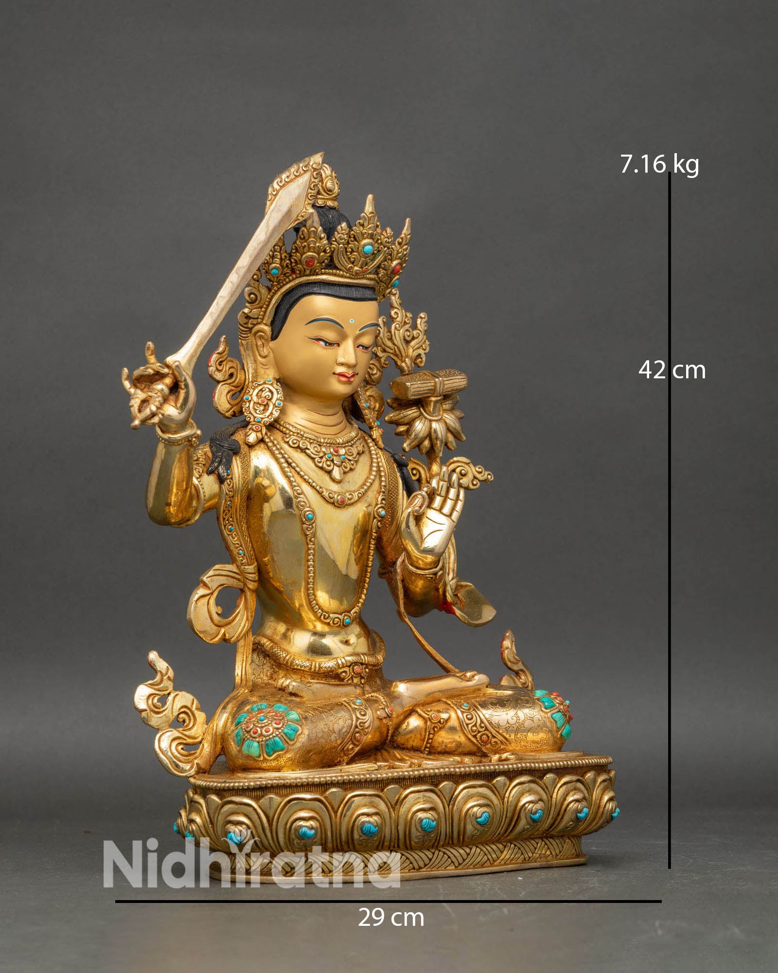 Side view of Manjushri holding flaming sword and Prajnaparamita sutra on lotus pedestal