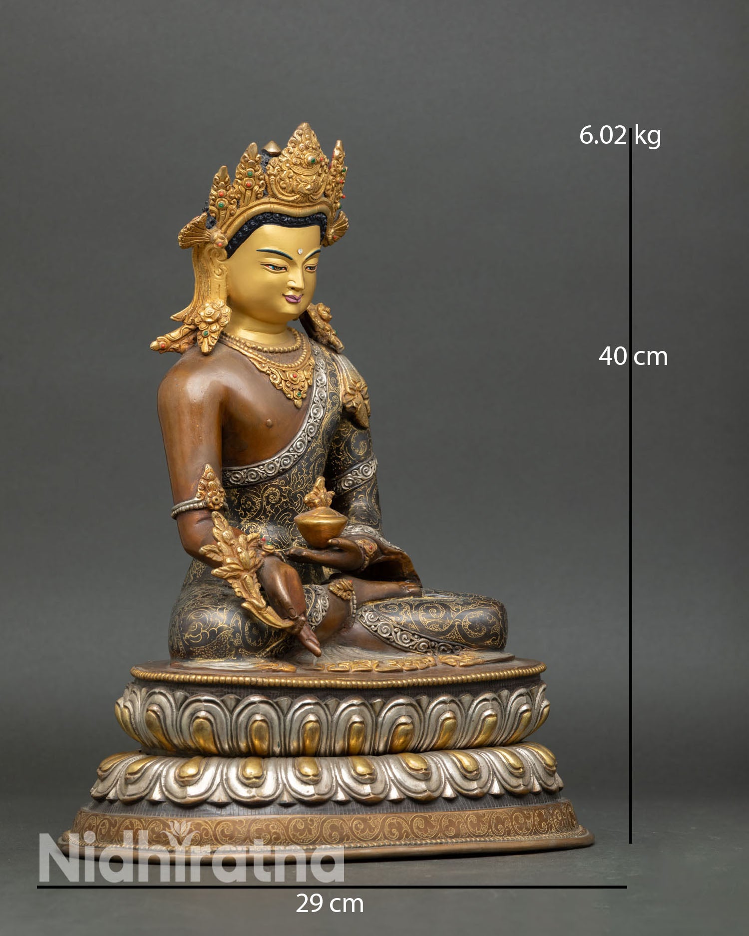 Side view of Medicine Buddha statue, seated on lotus pedestal holding healing nectar bowl