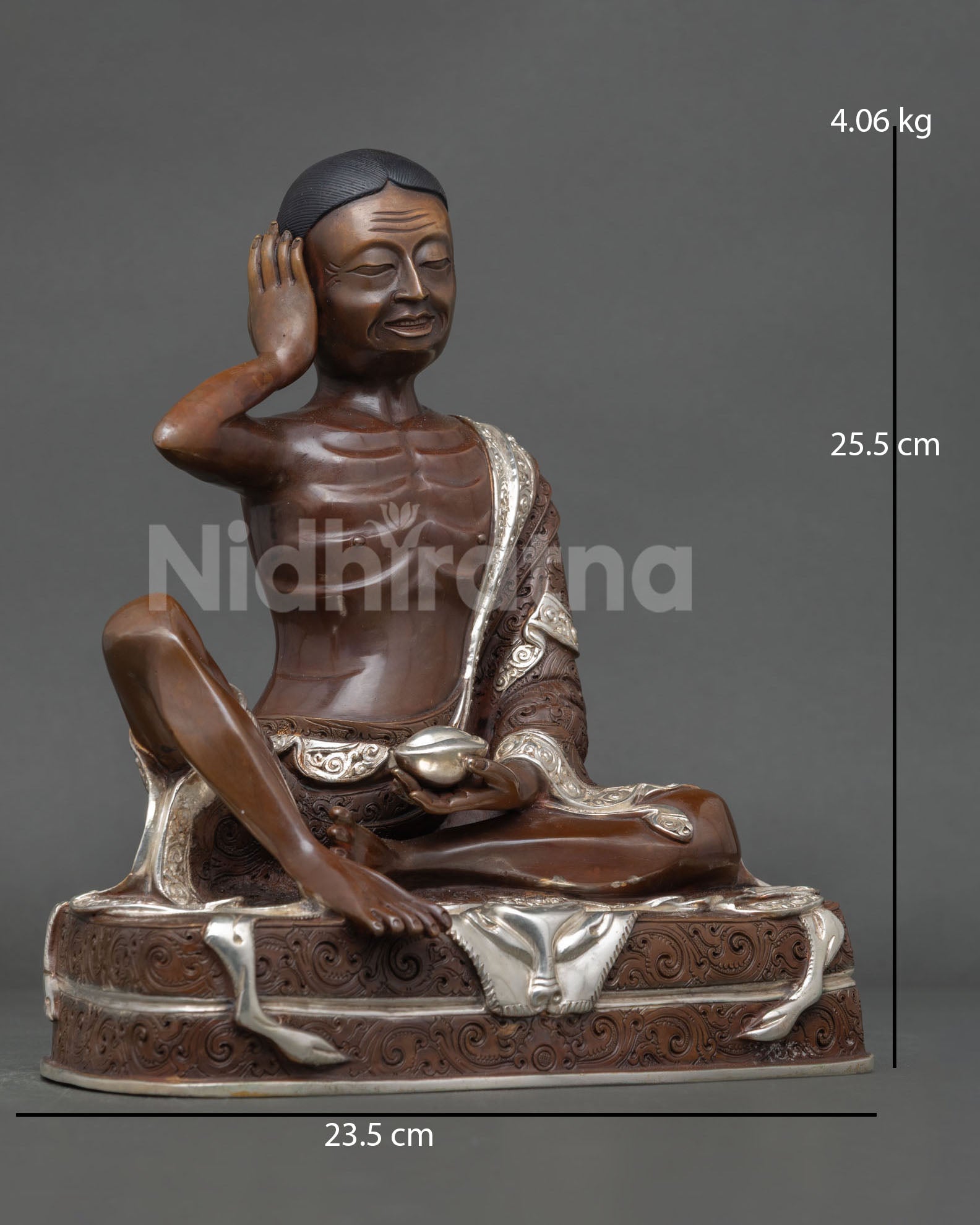 Side view of Milarepa sculpture, holding a skull cup, symbolizing spiritual awakening and transcendence over worldly attachments