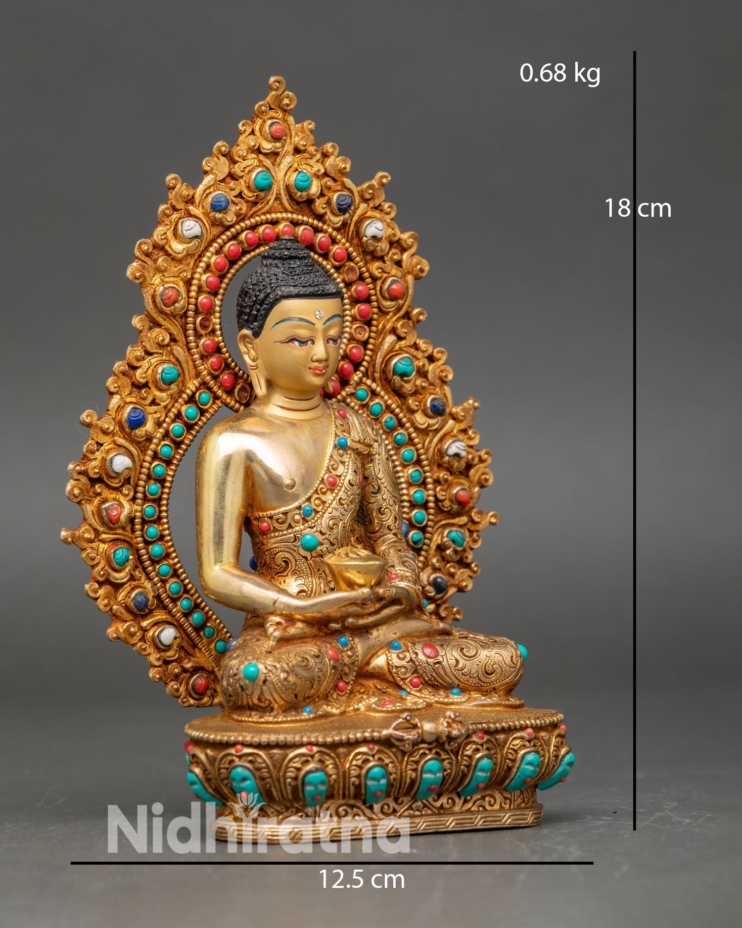 Side view of Amitabha Buddha statue on a lotus pedestal, with floral robes and semi-precious stones.
