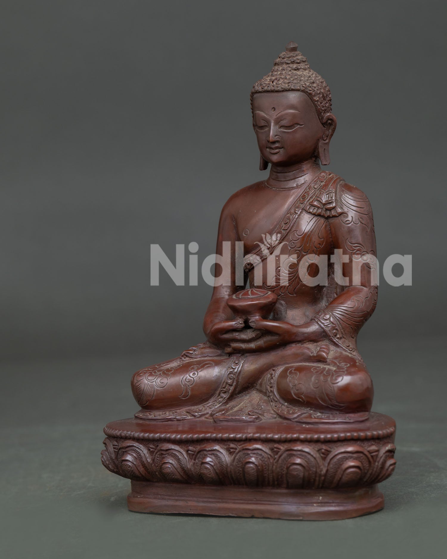 Side view of Amitabha Buddha Statue seated on lotus pedestal with oxidized copper finish details.