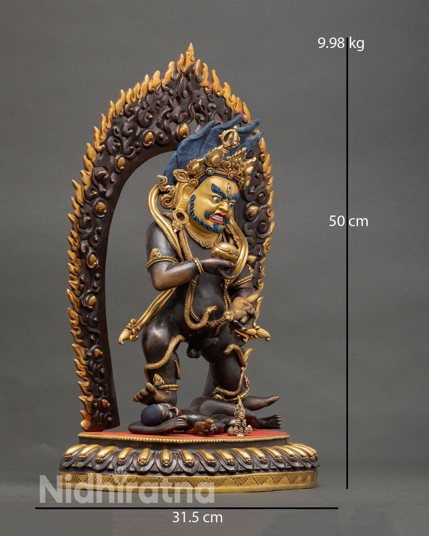 Side view of Black Dzambhala statue, ornate jewelry, kapala bowl, 24K gold gilding, blazing halo, tantric Buddhist art