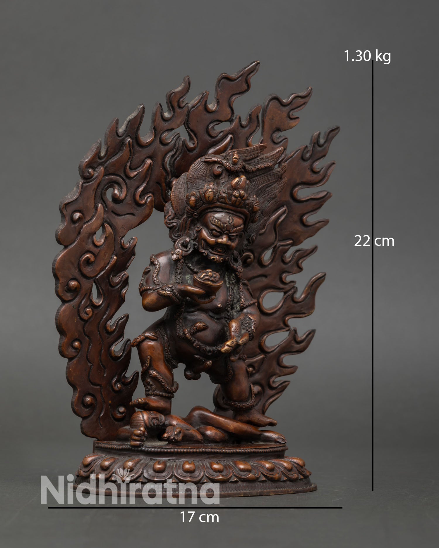 Side view of Black Dzambhala wealth deity statue, crafted in copper with oxidized finish, Buddhist art style.