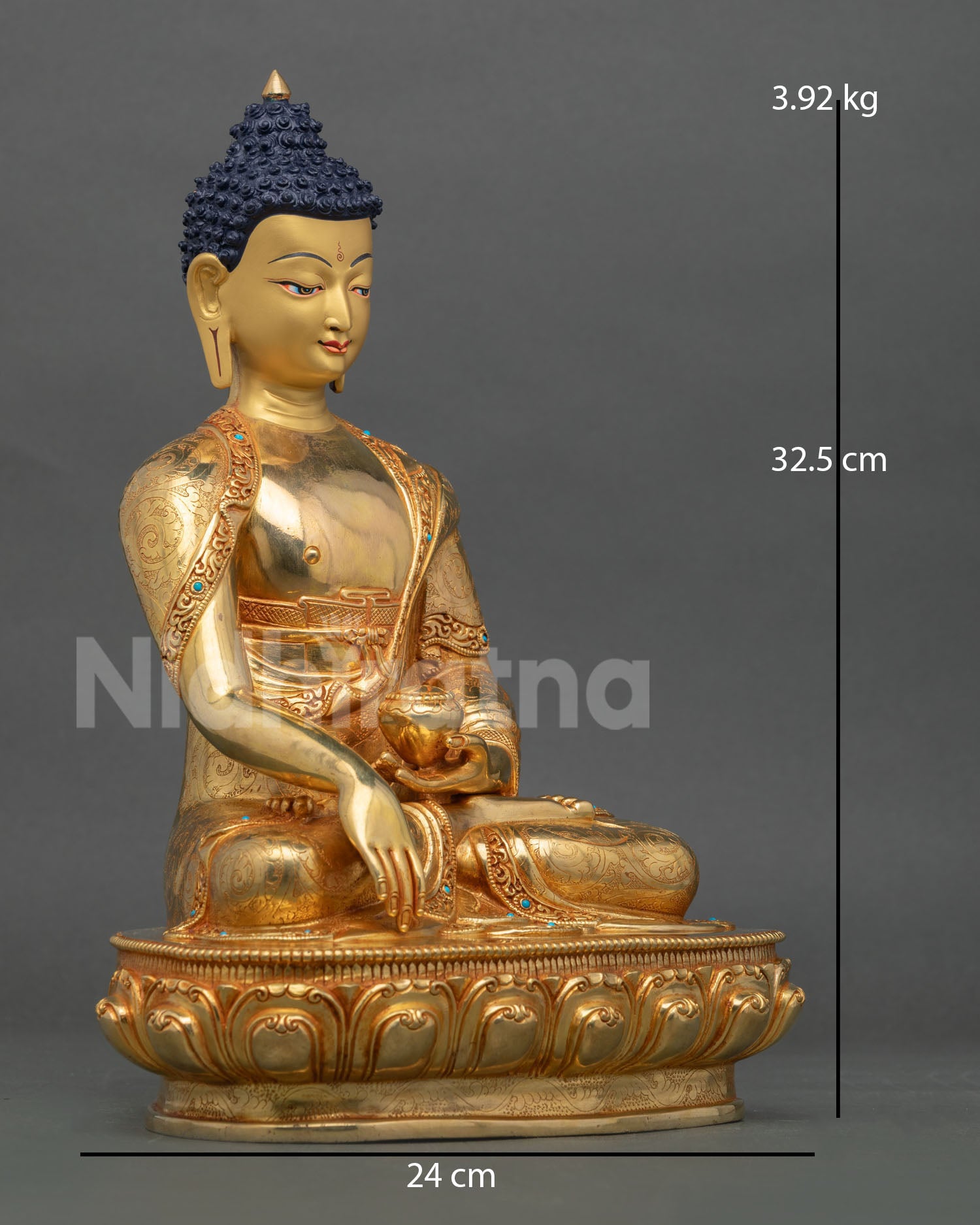 Side view of Buddha Shakyamuni statue in meditative posture on lotus pedestal with flowing robe and intricate Nepalese metal artistry